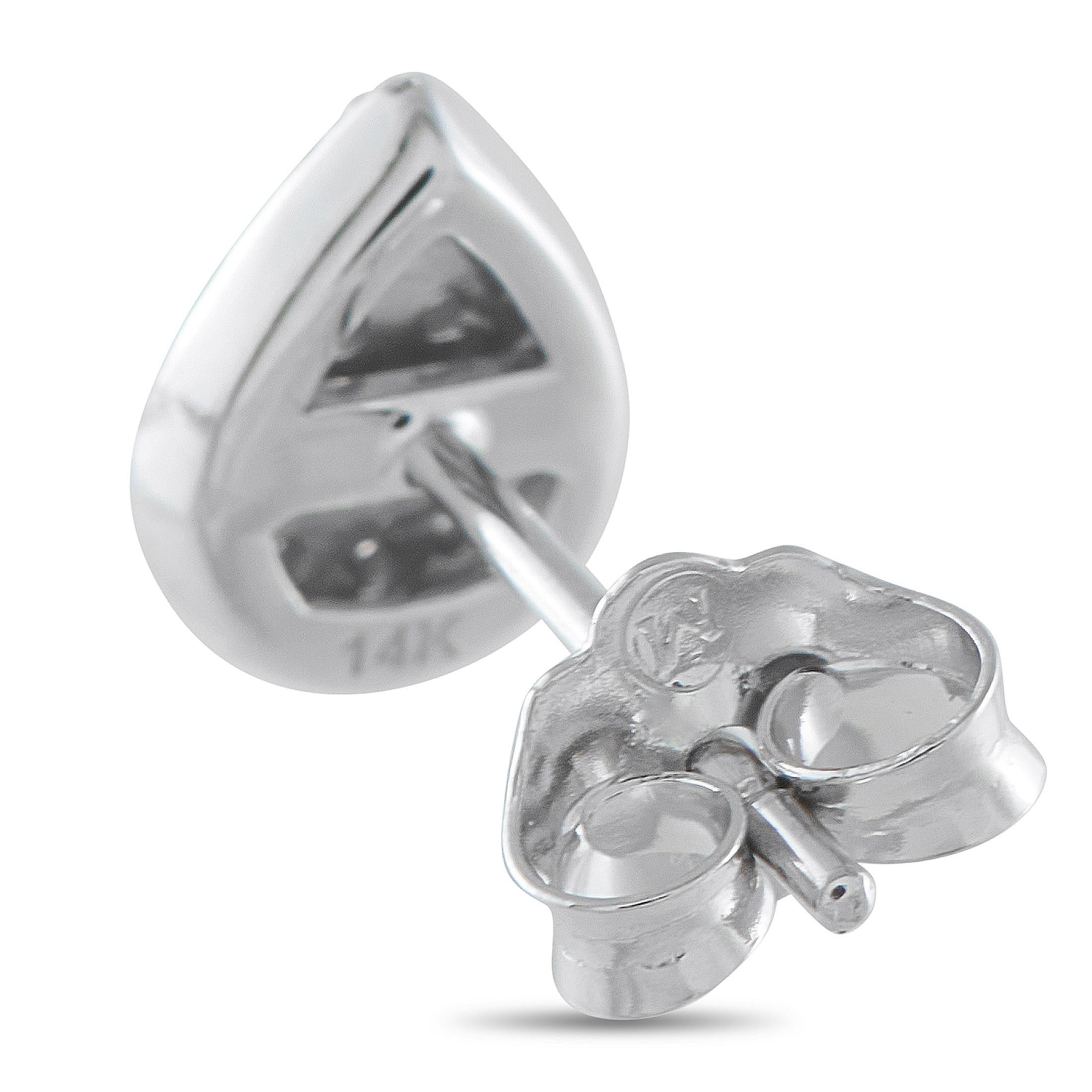 These earrings are elegant, understated, and ideal for everyday wear. Sparkling Diamonds with a total weight of 0.25 carats elevate the 14K White Gold setting and add a touch of luxury to any outfit. Each earring measures 0.44 long by 0.25 wide.This