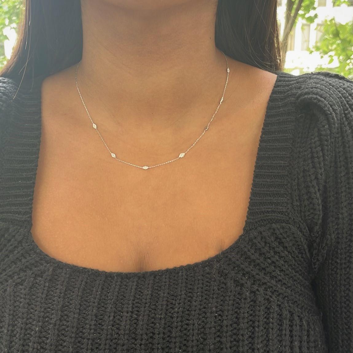 Graceful marquise shaped stations of diamonds set in 14k gold with cable chains between each form this lovely necklace for her. The 18-inch necklace has a total diamond weight of approximately 0.30 carat, and secures with a lobster clasp. Diamond