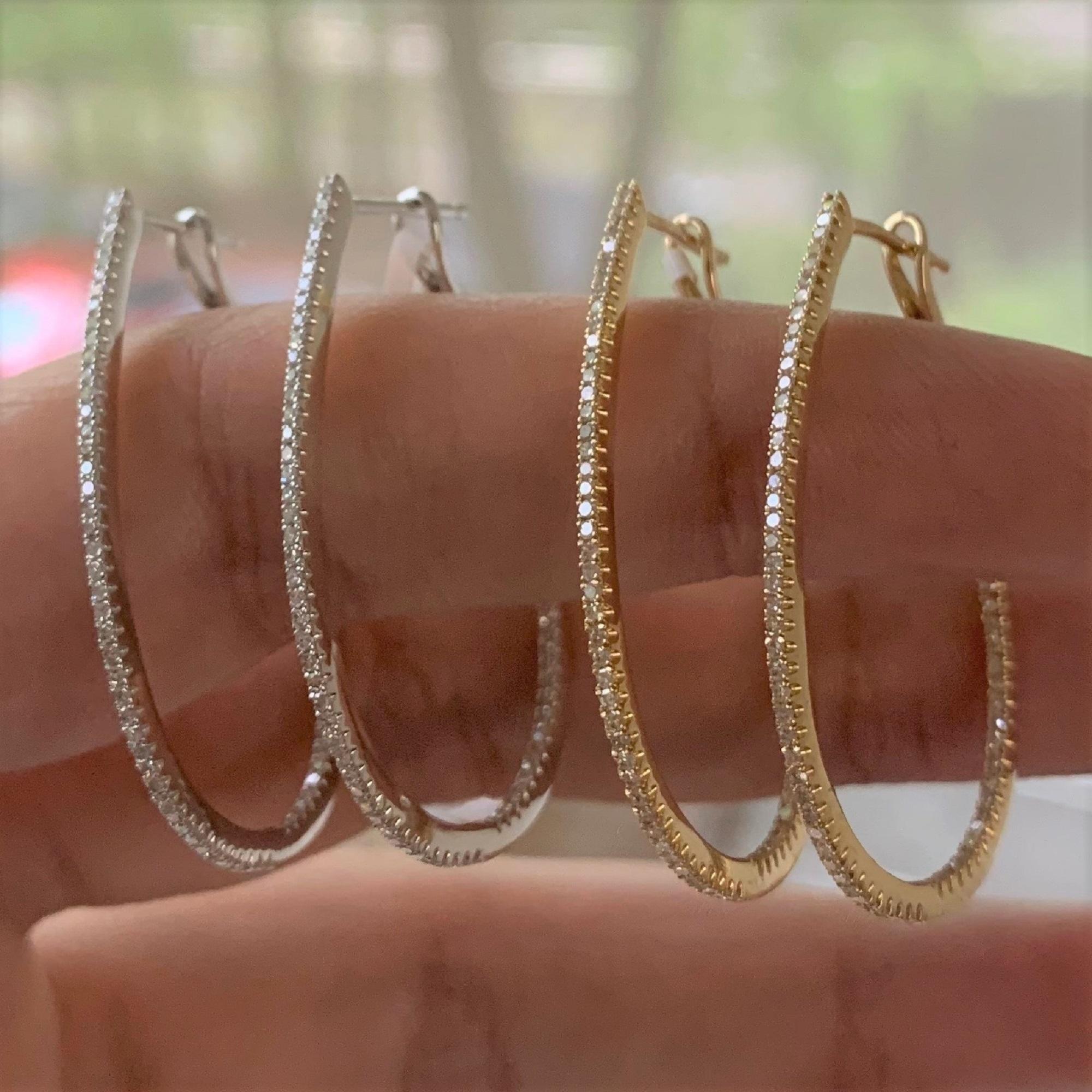 Set your lobes aglow in the classic shimmer and shine of these luxurious pear shape skinny hoop earrings! A dazzling array of diamonds fire up and down the design crafted from 14k white or yellow gold. Lever backs offer easy application so you can