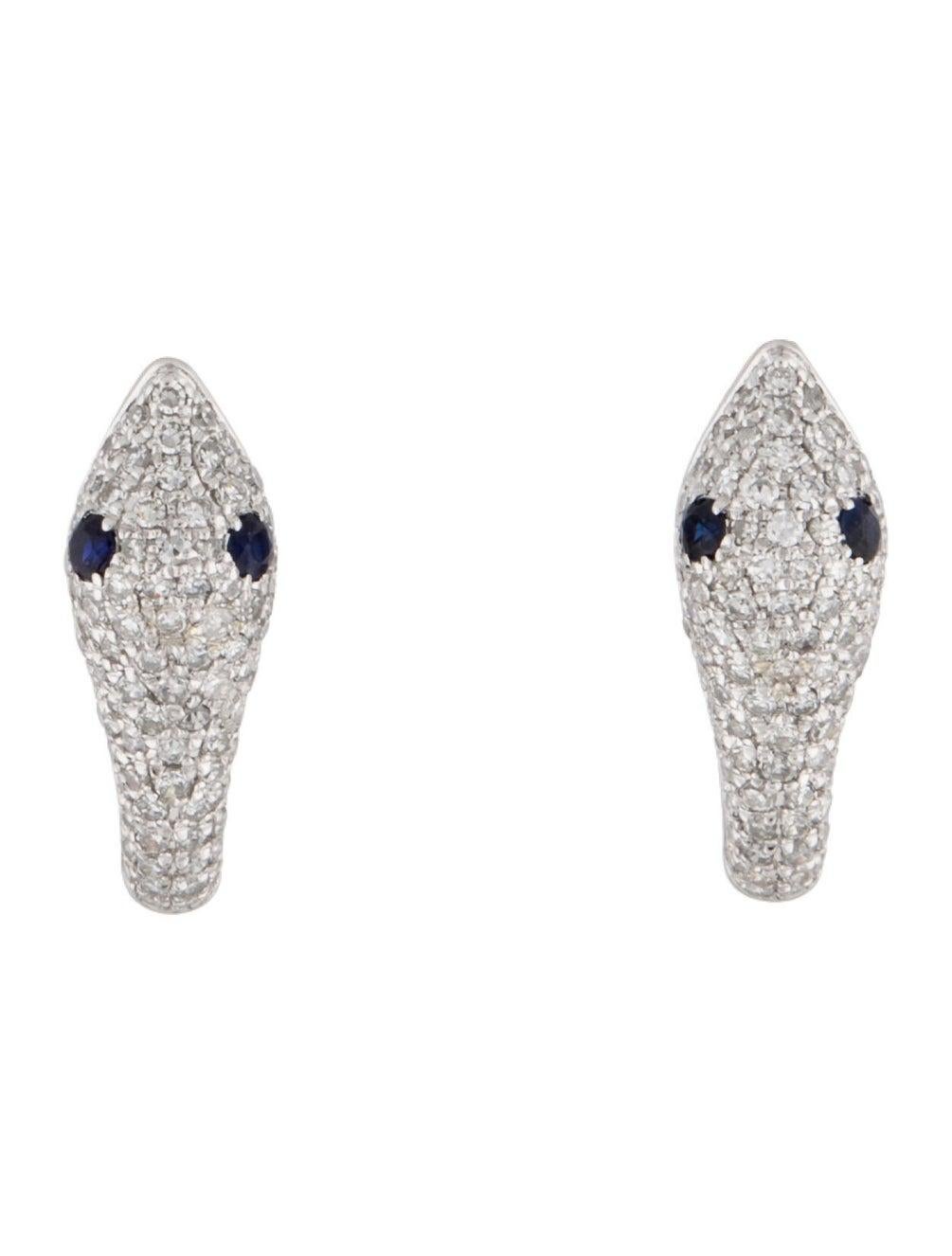 These Stylish and Chic Snake Earrings are crafted of 14K Gold featuring approximately 0.42 cts of round Diamonds & 2 Sapphires weighing 0.14cts Secured with Hinged backs.
-14K Gold
-0.42cts Natural White Diamonds
-0.14cts Sapphire
-Diamond Color