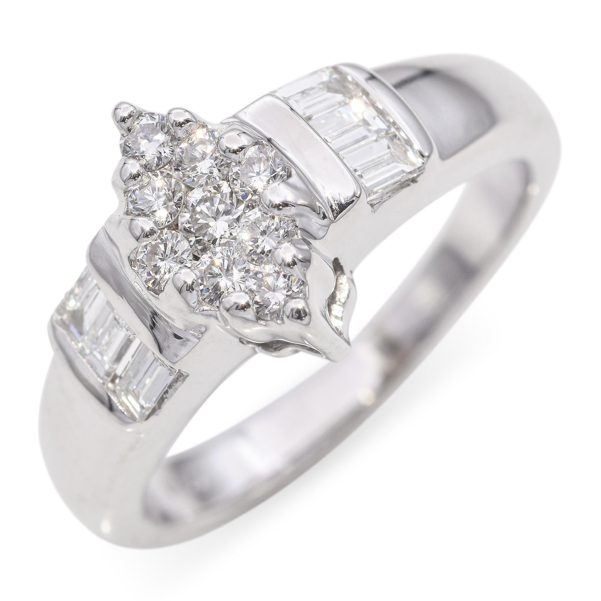 A stunning engagement ring crafted in 14k white gold. This exquisite piece features a cluster of round-cut diamonds, totaling 0.17 carats, with a brilliant white hue. The diamonds are arranged in a captivating marquise design that draws the eye to
