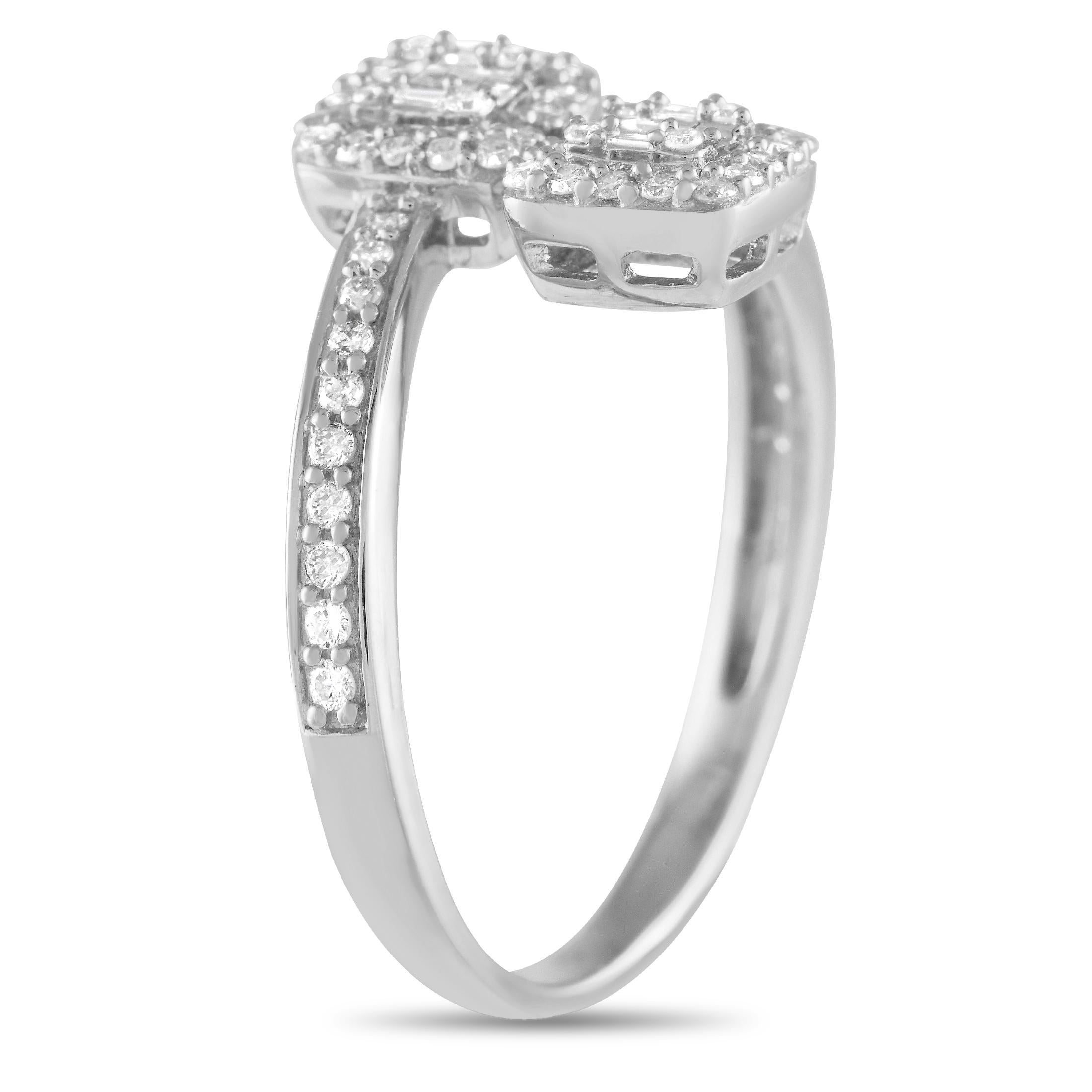 Looking for something unexpected and utterly charming? Take a look at this bypass ring. It is rendered in 14K white gold, with a slim shank with diamond-traced shoulders. The two ends of the bypass shank are detailed with a square-shaped cluster of