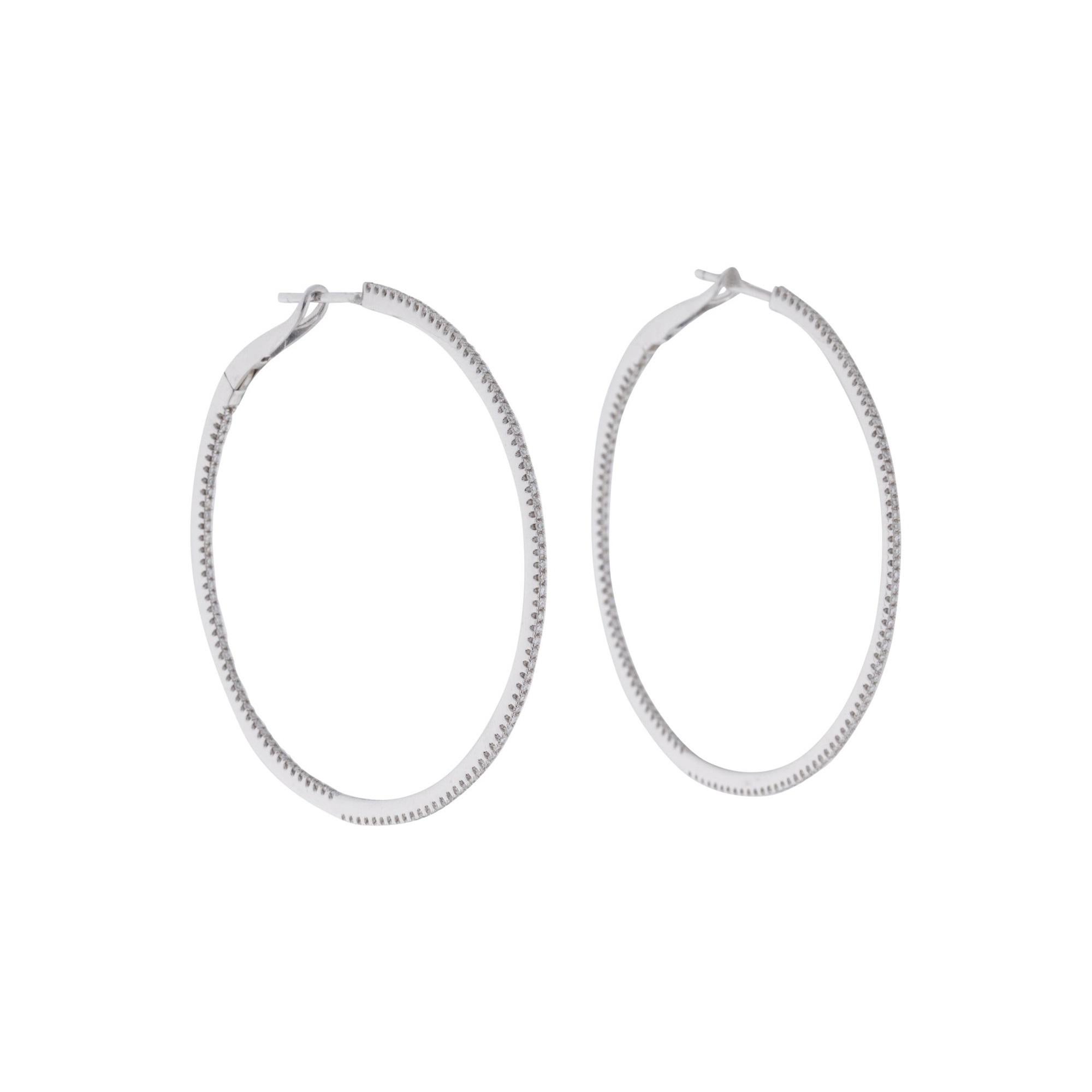 Light up your favorite looks with the brilliance of diamonds! Shimmering and bright, these gorgeous narrow round hoops glisten with approximately 0.59ct diamonds along the outer edge. Diamond color and clarity is GH SI1-SI2. Lever backs provide a