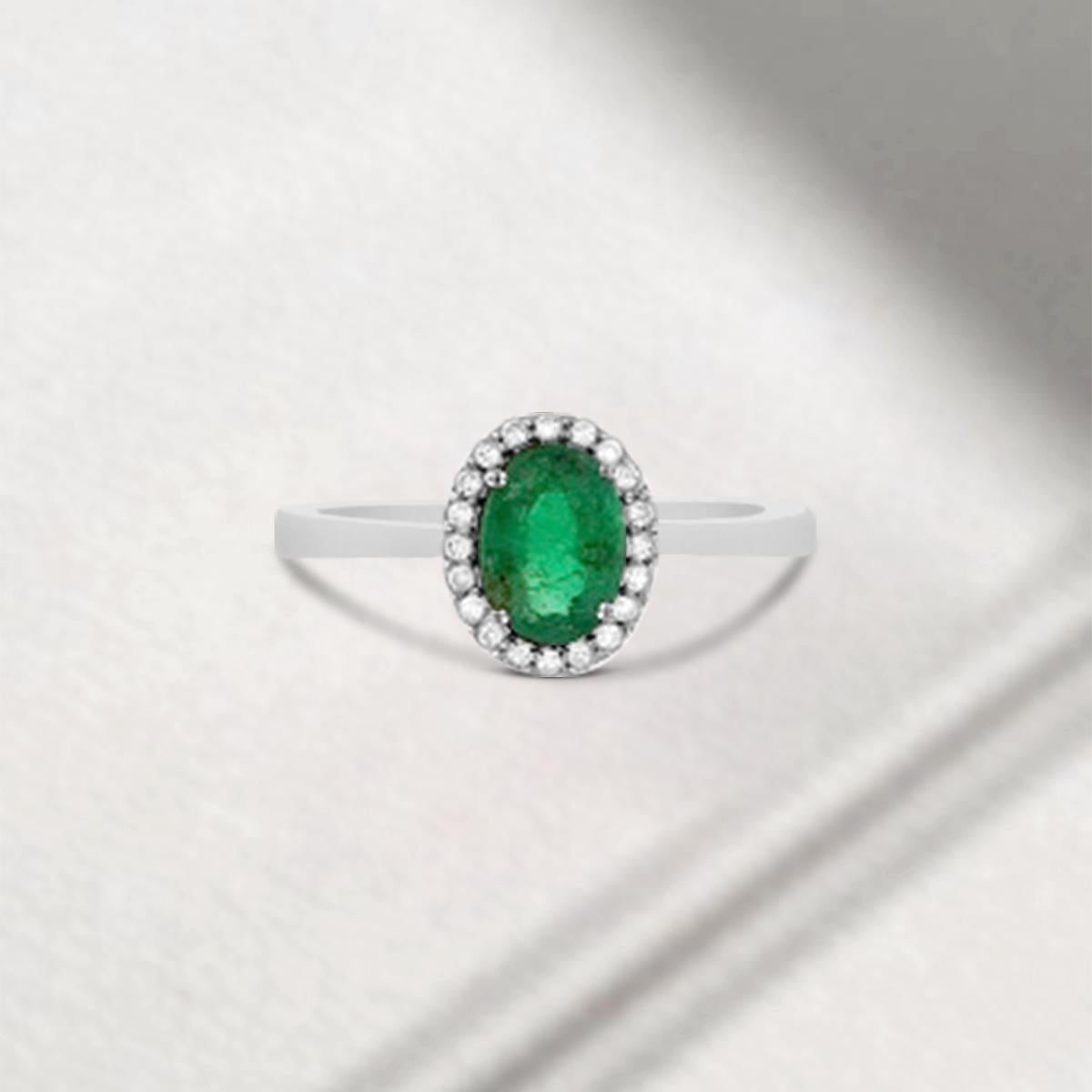 This Gorgeous Green Goddess Is Stunningly Beautiful! The Unique Emerald Ring With Diamonds Features A Genuine And Natural Oval Shape 7X5mm Green Emerald That Is Complimented By  Diamonds In A Halo Fashion. The Colored Gemstone and Diamonds Rest On