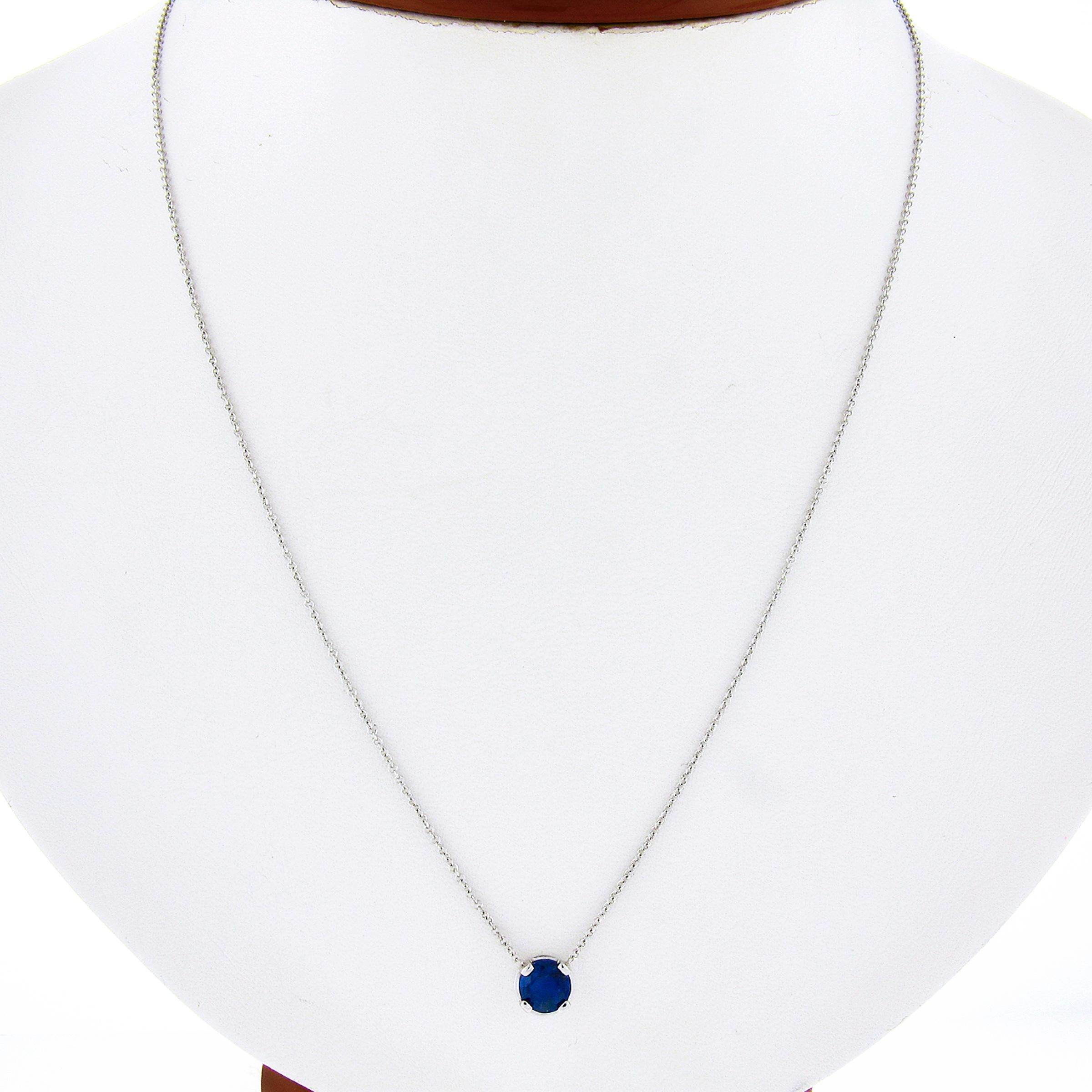 You are looking at a simple and classically styled sapphire solitaire pendant that is crafted in solid 14k white gold. The round cut sapphire in this pendant displays an absolutely gorgeous fine blue color showing remarkable amount of shine due to