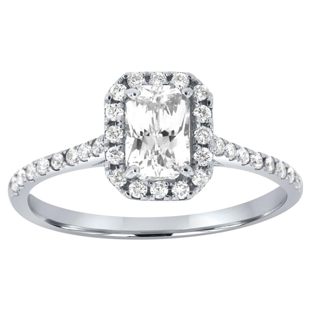 This 14K White gold ring set features a 0.86-carat non-heated Elongated Radiant Natural White Sapphire encircled by a halo of brilliant round diamonds, Micro-Prongs set on top of a 1.4mm wide band. A perfectly matching diamond band completes this
