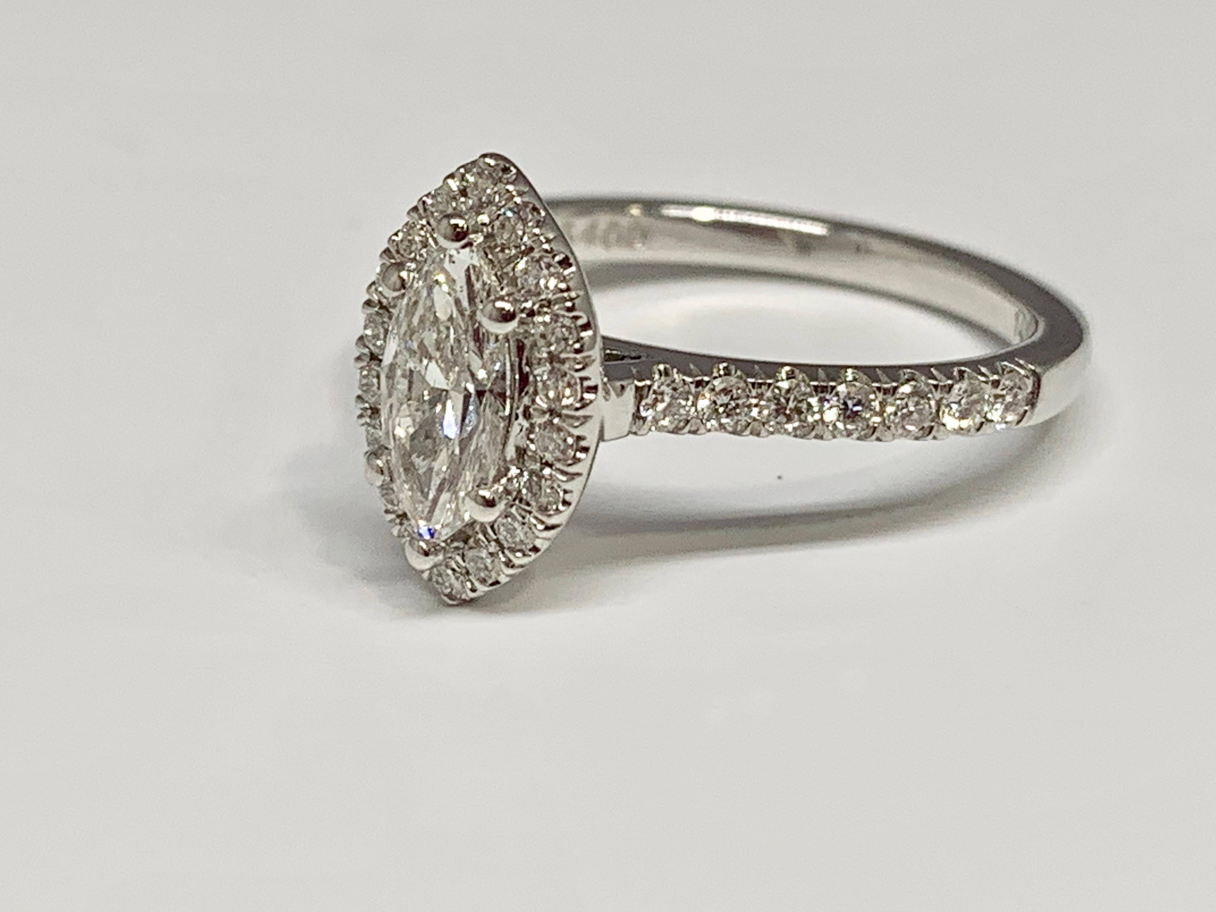 This vintage inspired engagement ring from Martin Flyer features a 0.51 carat Marquise center diamond that is GIA certified. The color grade of the center diamond is E and the clarity grade is SI2. The size 6.5 micro pave mounting is made of 14K