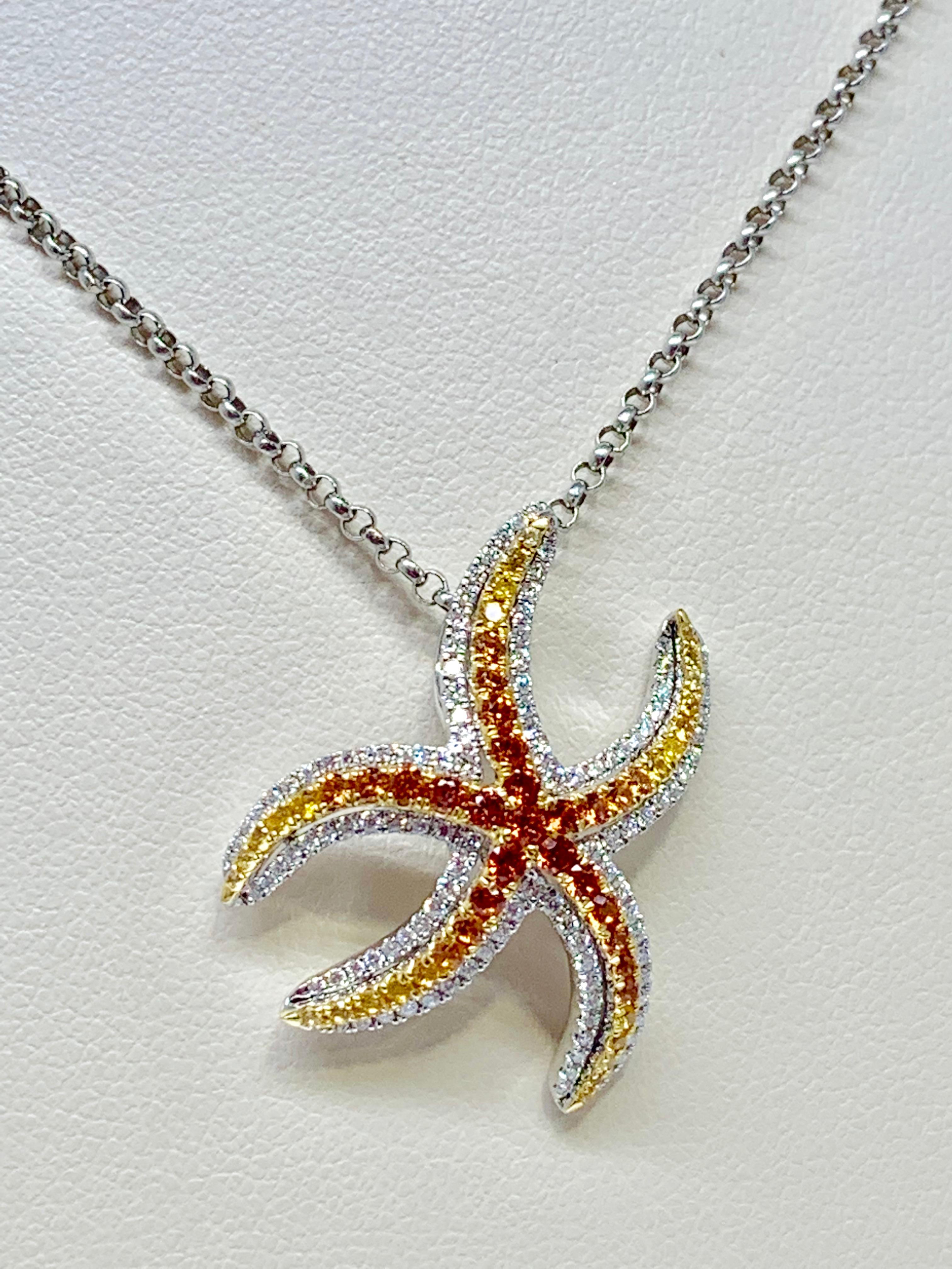 This vibrant 14K white gold starfish necklace features 0.52 carats of round yellow and orange sapphires as well as 0.38 carats of round white diamonds. This necklace includes a 14K white gold 18