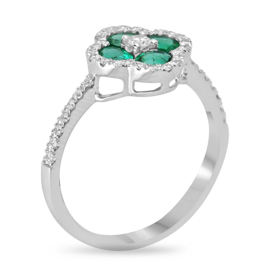 Introducing our Emerald and Diamond Oval Ring, a true symbol of sophistication and luxury. At its heart, four exquisite emeralds are meticulously arranged in the shape of an oval, with a brilliant round cut diamond as their crowning jewel,