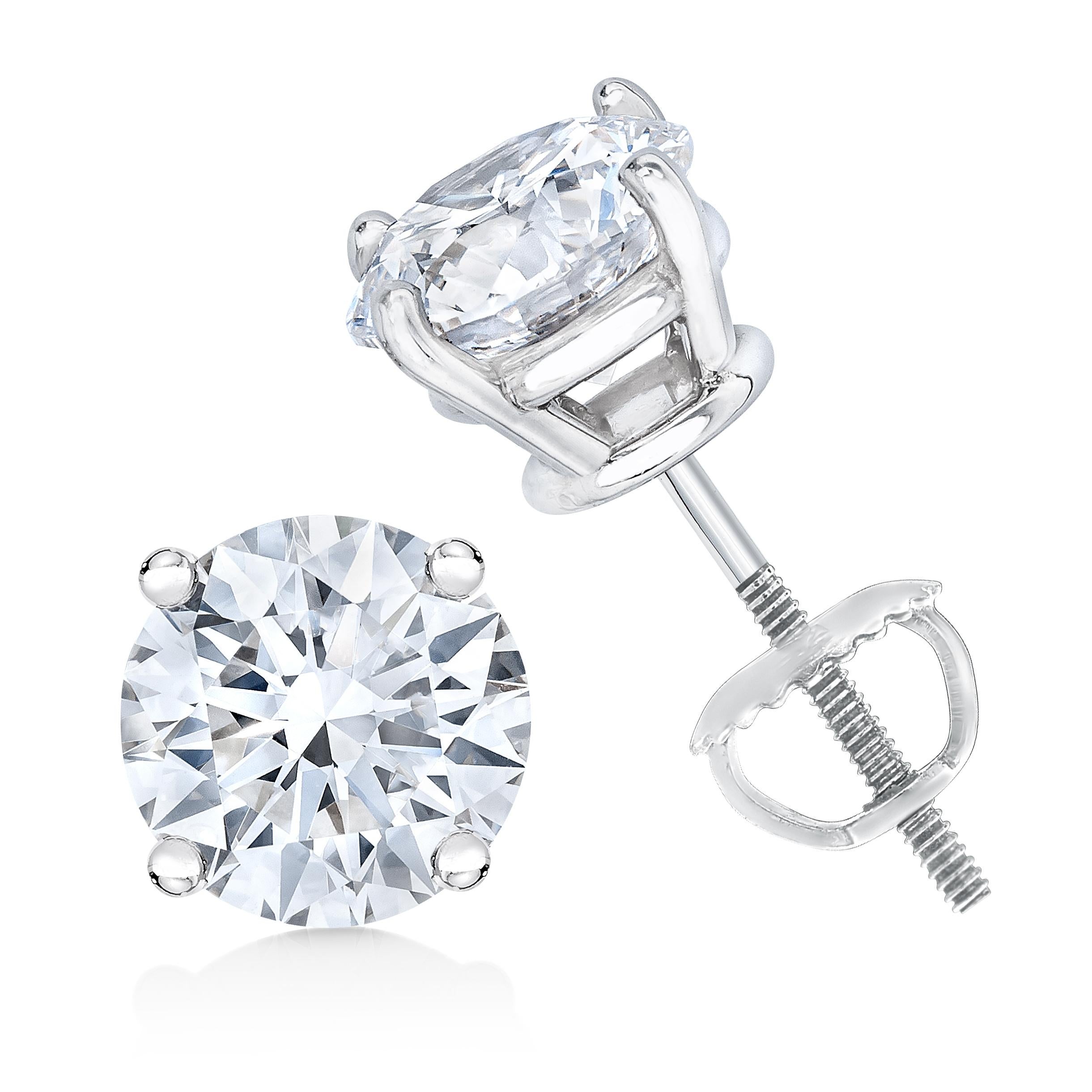 Two gorgeous white diamonds sit in a prong setting on these sparkling stud earrings. Crafted in 14k white gold, these diamond stud earrings feature a high polish finish with a screw on mechanism to secure. These stunning gold earrings feature 1.5
