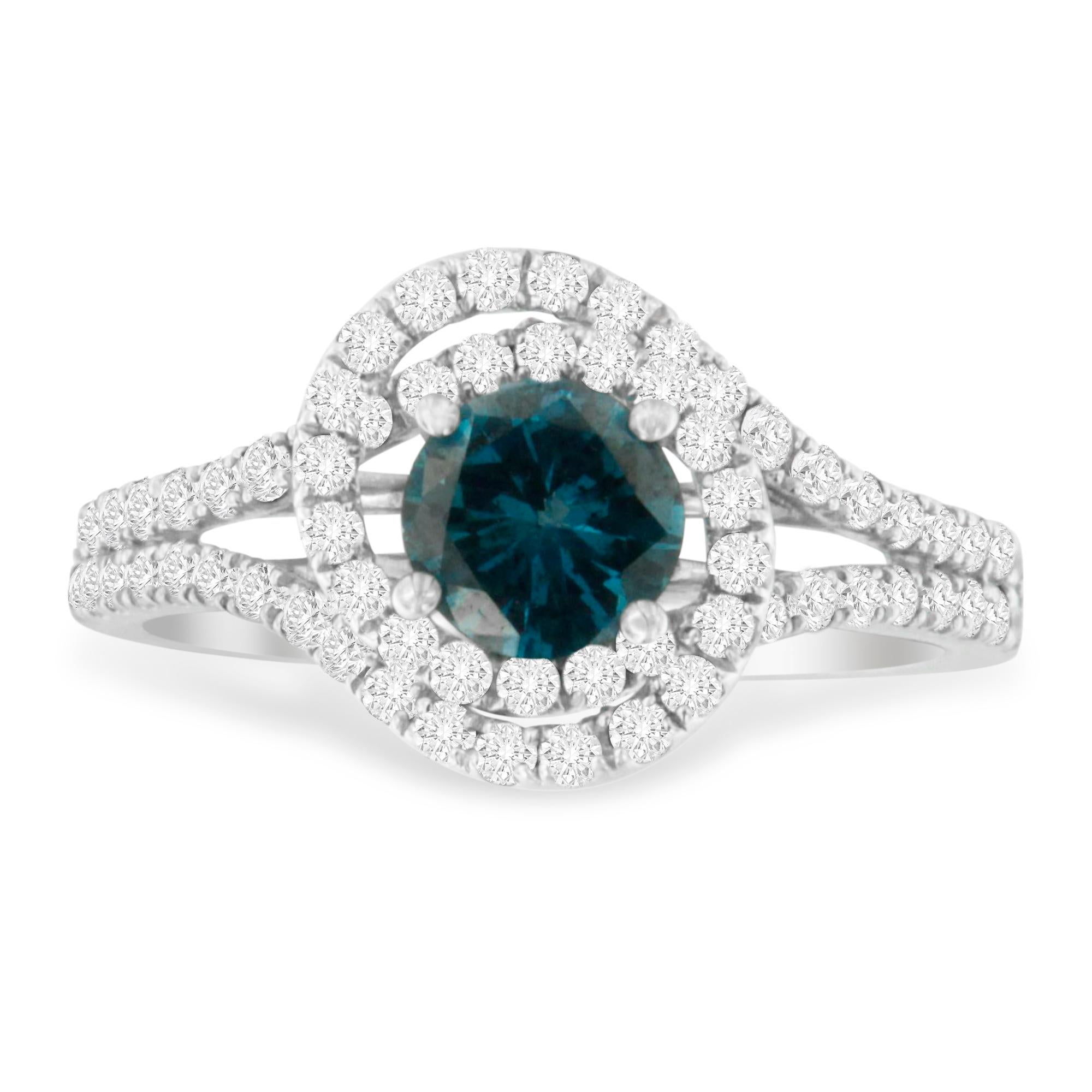 This charming ring features a .75 round treated blue diamond in the center surrounded by a halo of round white diamonds. The split shank band set with further round diamonds adds extra sparkle to this design. It has a total diamond weight of 1 1/3
