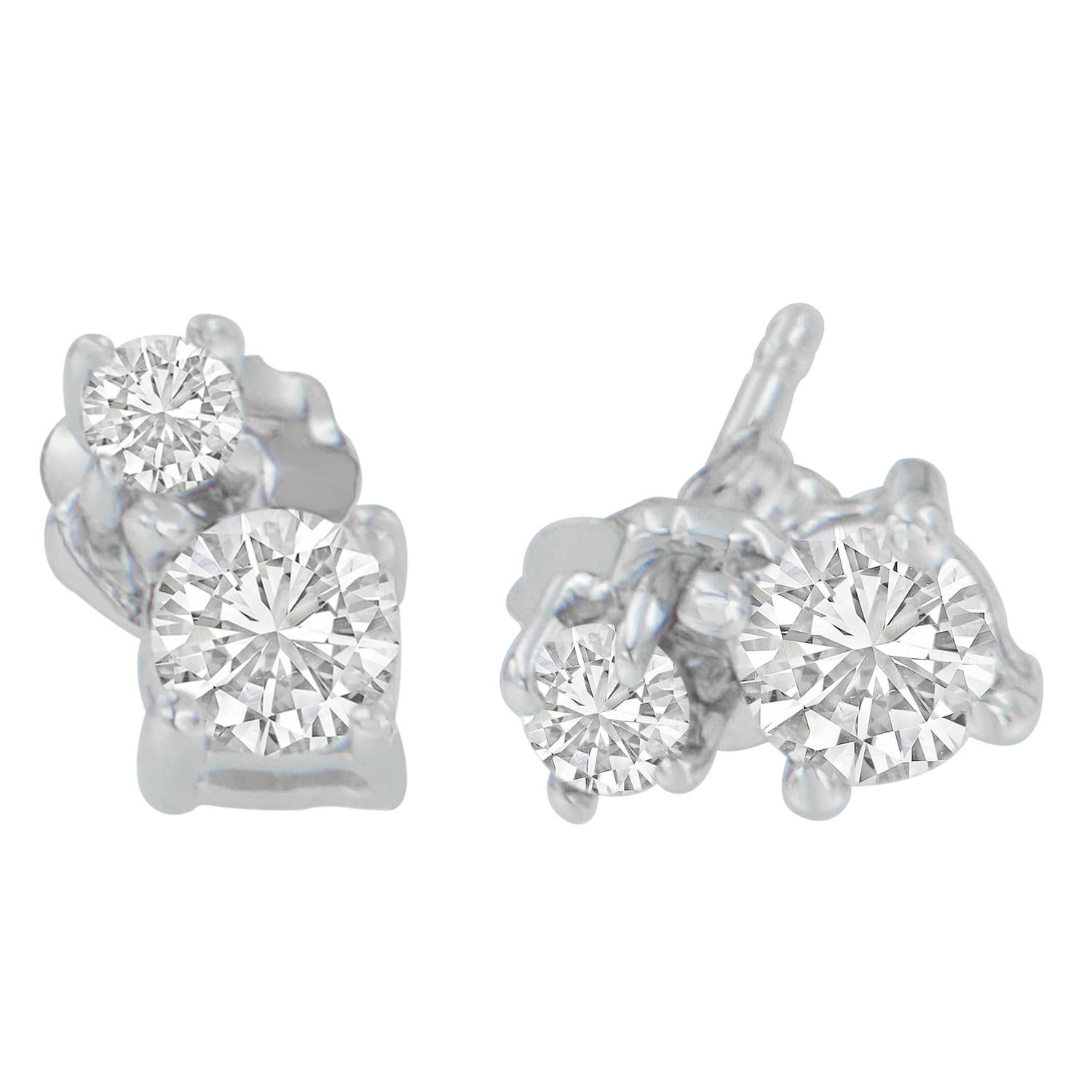 Decorate your earrings like a star with these beautiful dangle diamond earrings. Brilliant choice to wear with any outfit, the lovely pair of earrings is composed of 14 karats white gold. Each of the earrings features two round cut diamonds in a