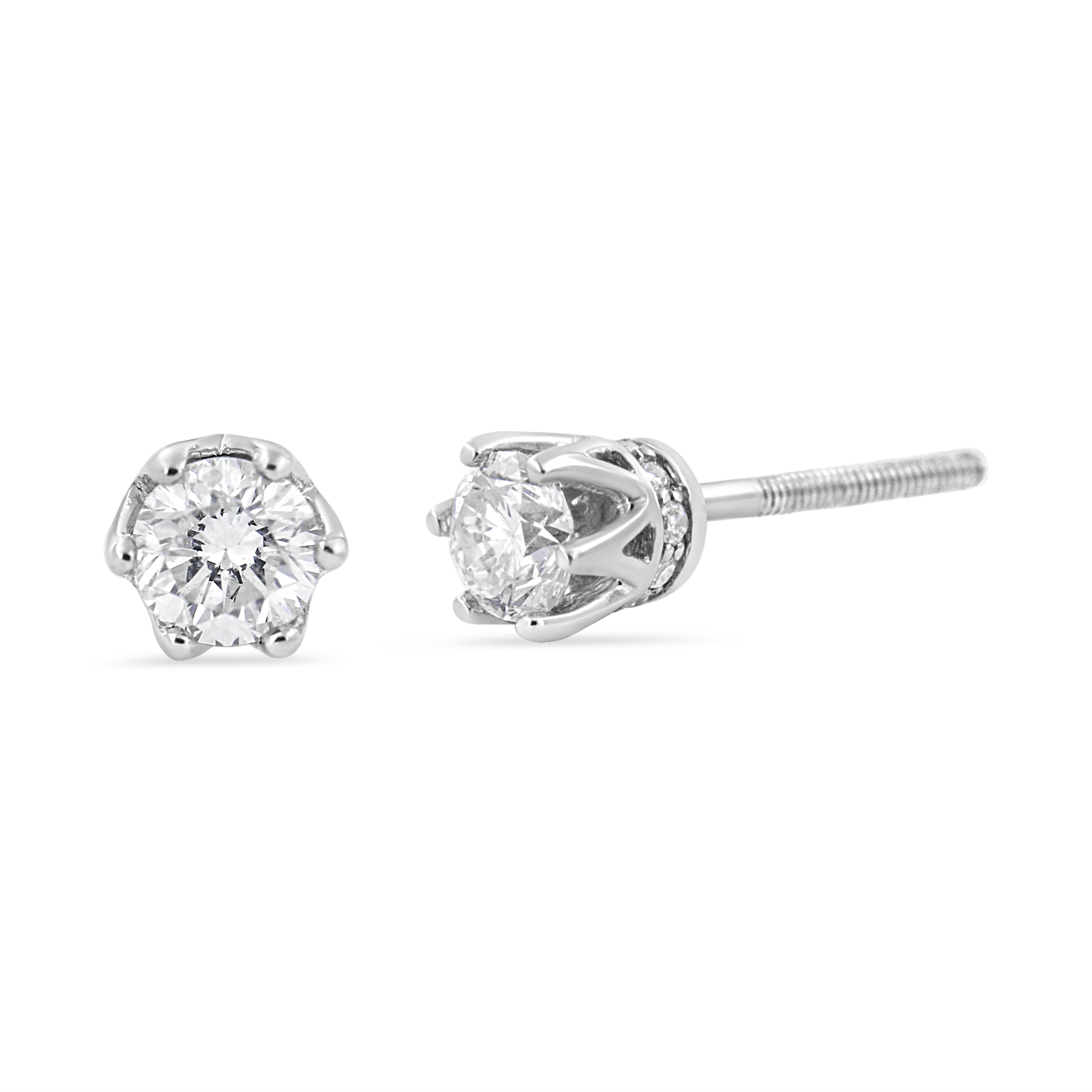 With regal hidden details, these diamond stud earrings are anything but ordinary. From the front, these 14kt white gold studs look like solitaires with a multi-prong setting. But the sideview brings into focus the crown design. Round diamond accents