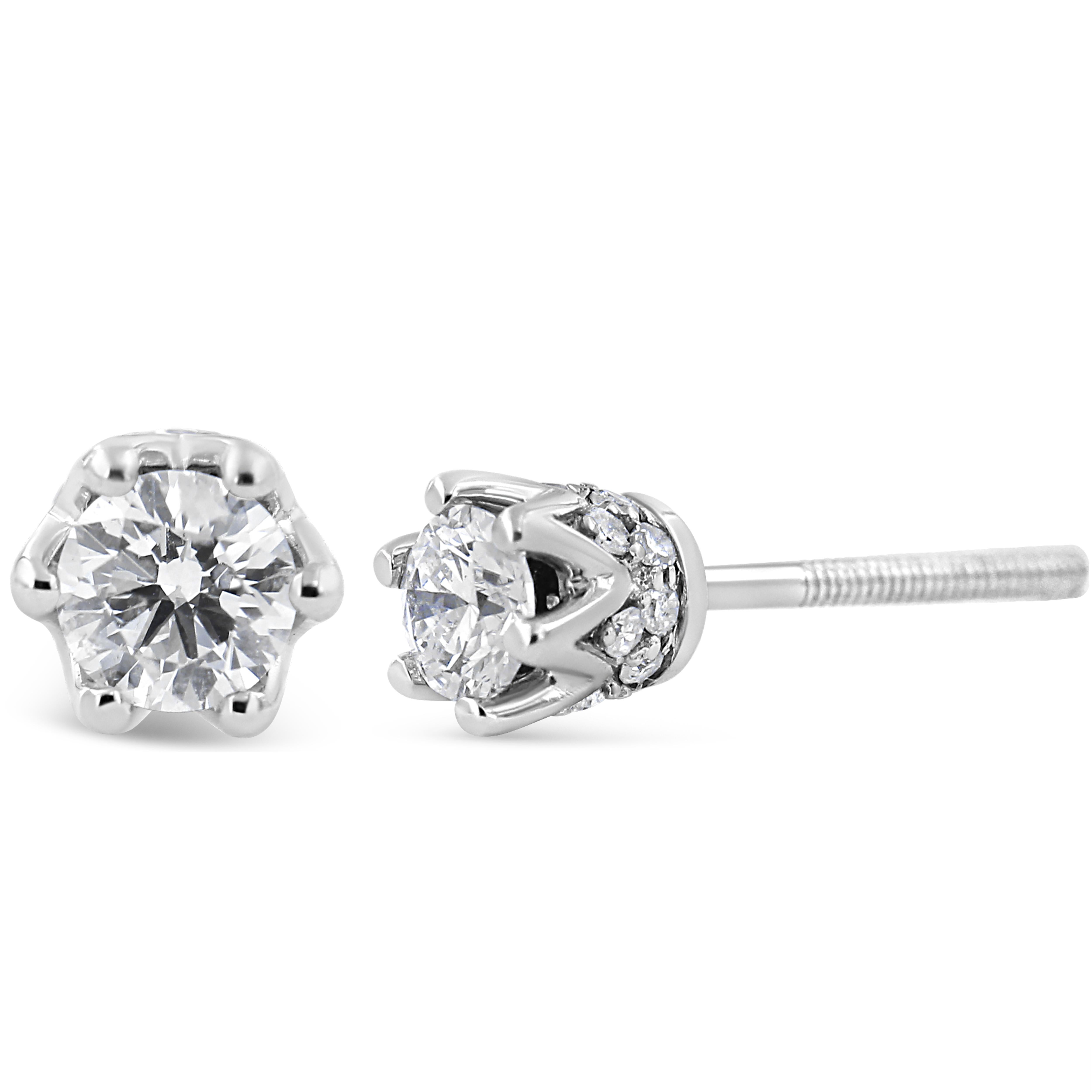 With regal hidden details, these diamond stud earrings are anything but ordinary. From the front, these 14kt white gold studs look like solitaires with a multi-prong setting. But the sideview brings into focus the crown design. Round diamond accents