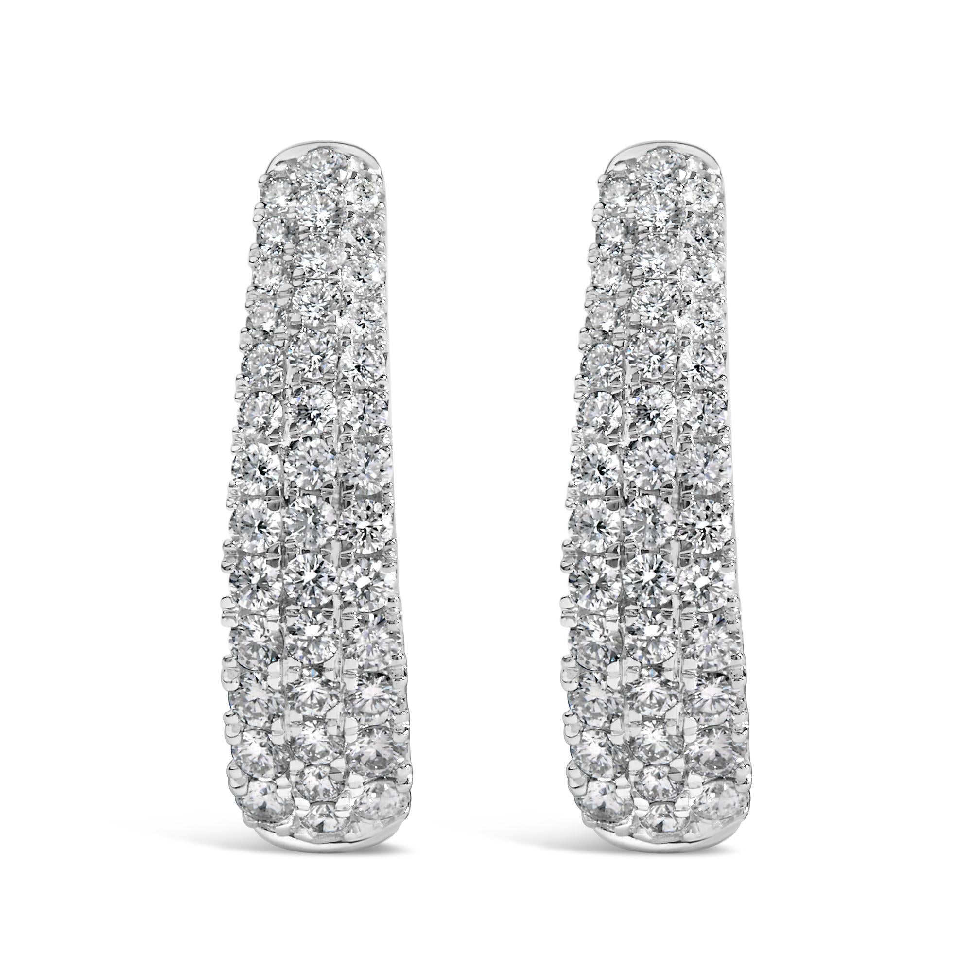 Discover opulence that dangles delicately with these 14K white gold hoop earrings, where elegance meets a spark of brilliance. These exquisite jewels, gleaming with a rhodium finish for that extra touch of luster, introduce a mesmerizing pave of