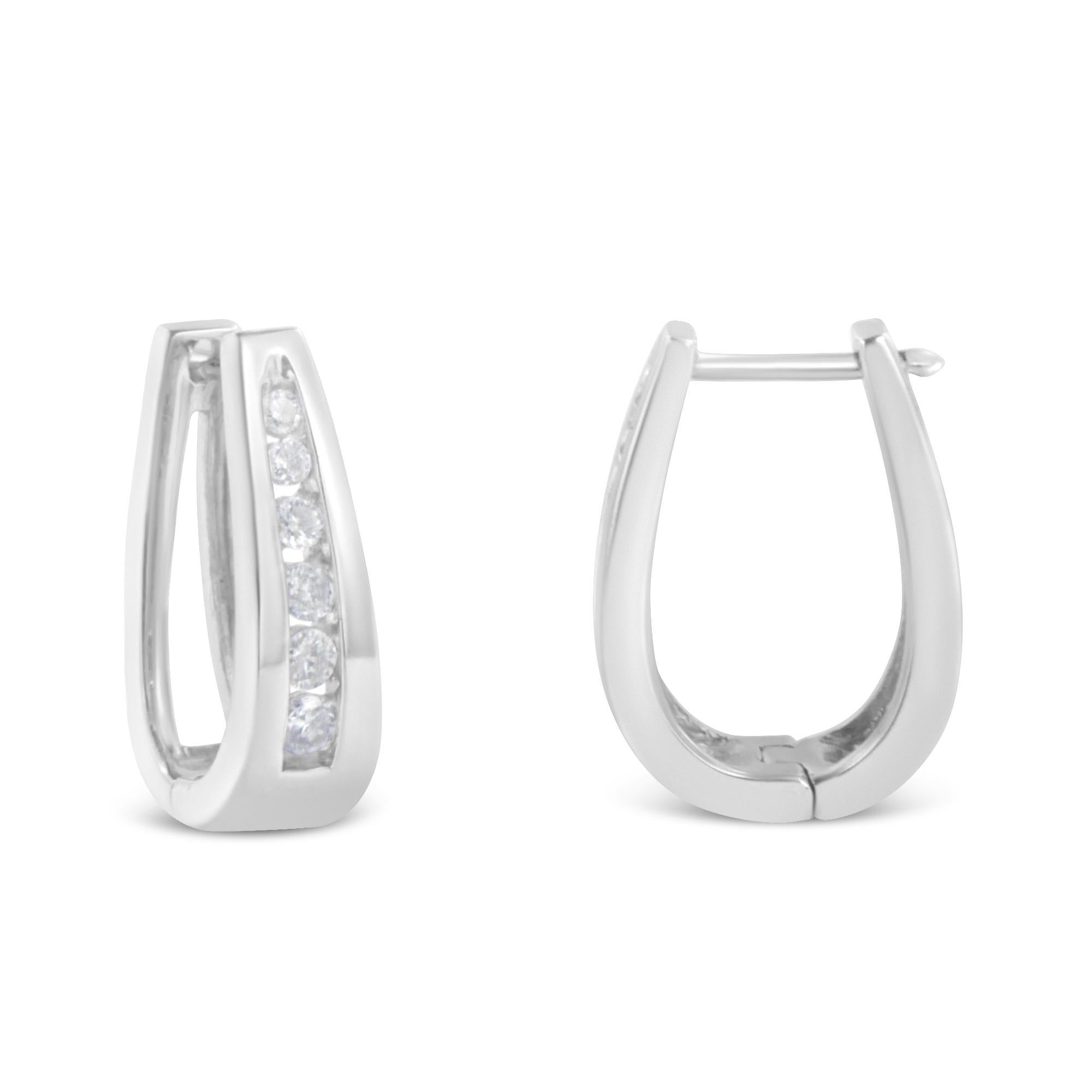 Fashioned in stunning 14k white gold, these beautiful hoop earrings feature 1/4ct of brilliant round cut diamonds in a channel setting that delicately flow half way around the outside of the hoop. A classic piece you can wear everyday. These