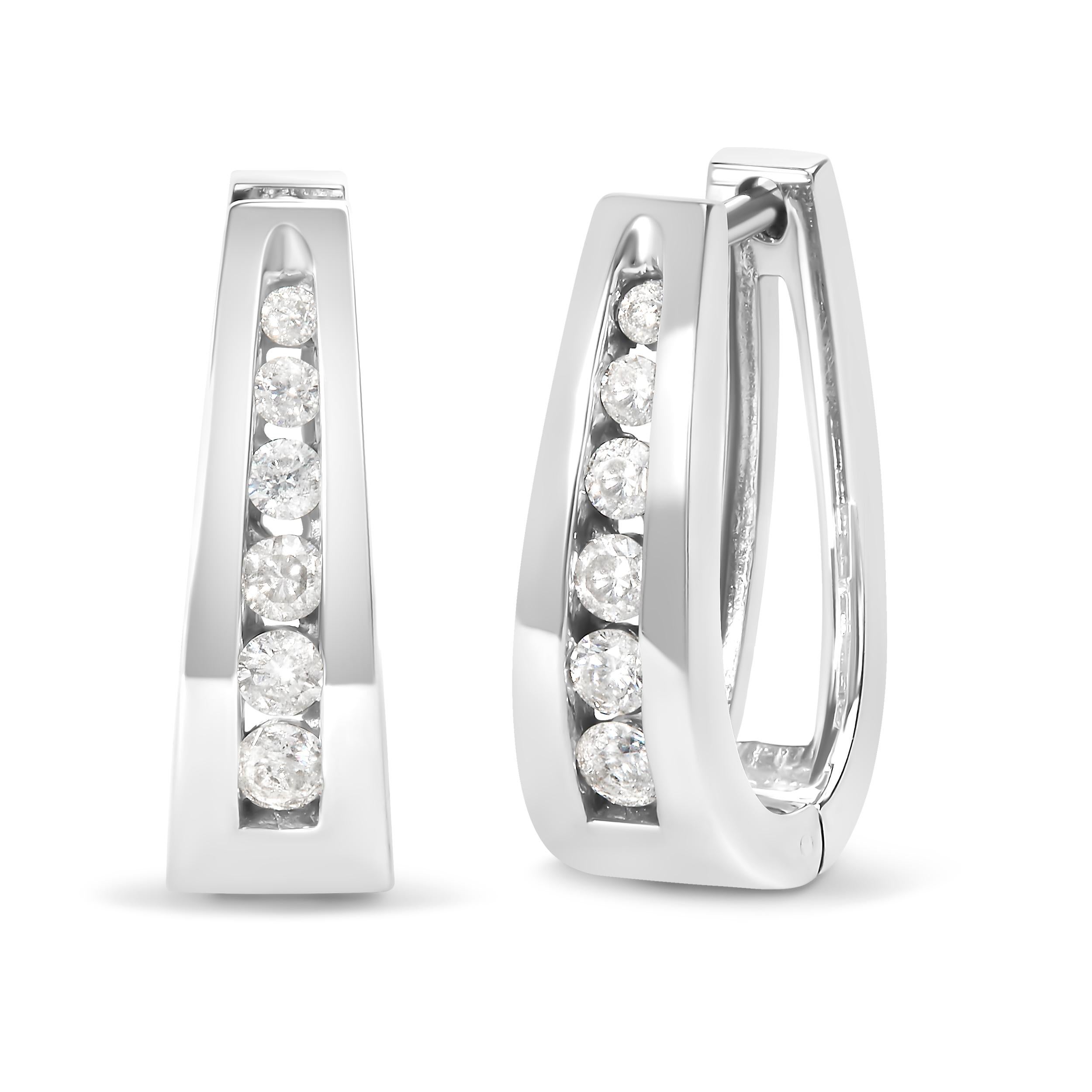 Immerse yourself in the exquisite elegance of these slender, slightly tapered hoop earrings, meticulously crafted from 14K white gold for a modern and sleek aesthetic that whispers sophistication into every occasion. Each piece is adorned with a