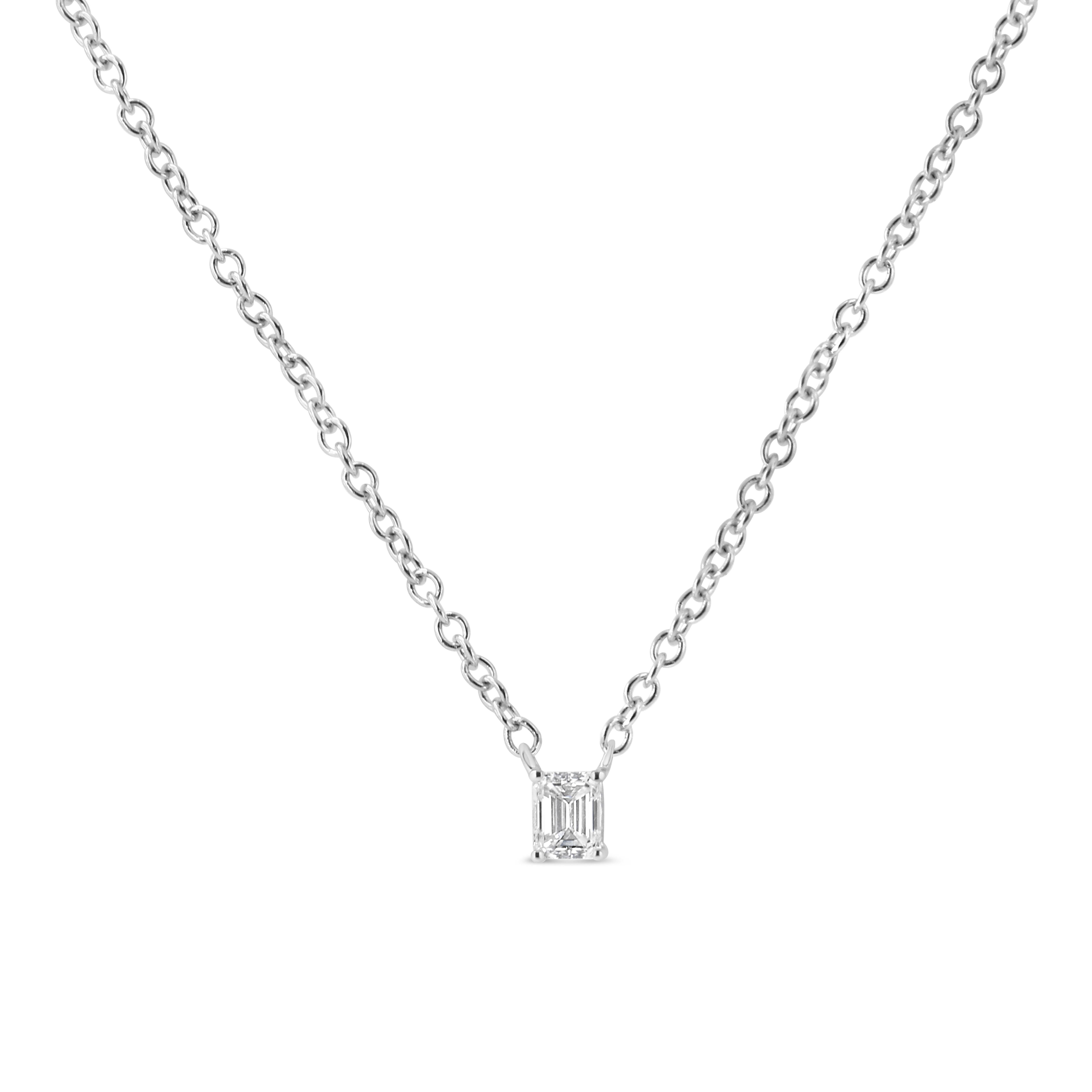 Elevate your everyday look with this unique 1/5 cttw solitaire diamond pendant. This beautiful necklace is crafted in 14k white gold, a metal that will stay tarnish free for years to come. The diamond has a unique emerald shape and is embellished in