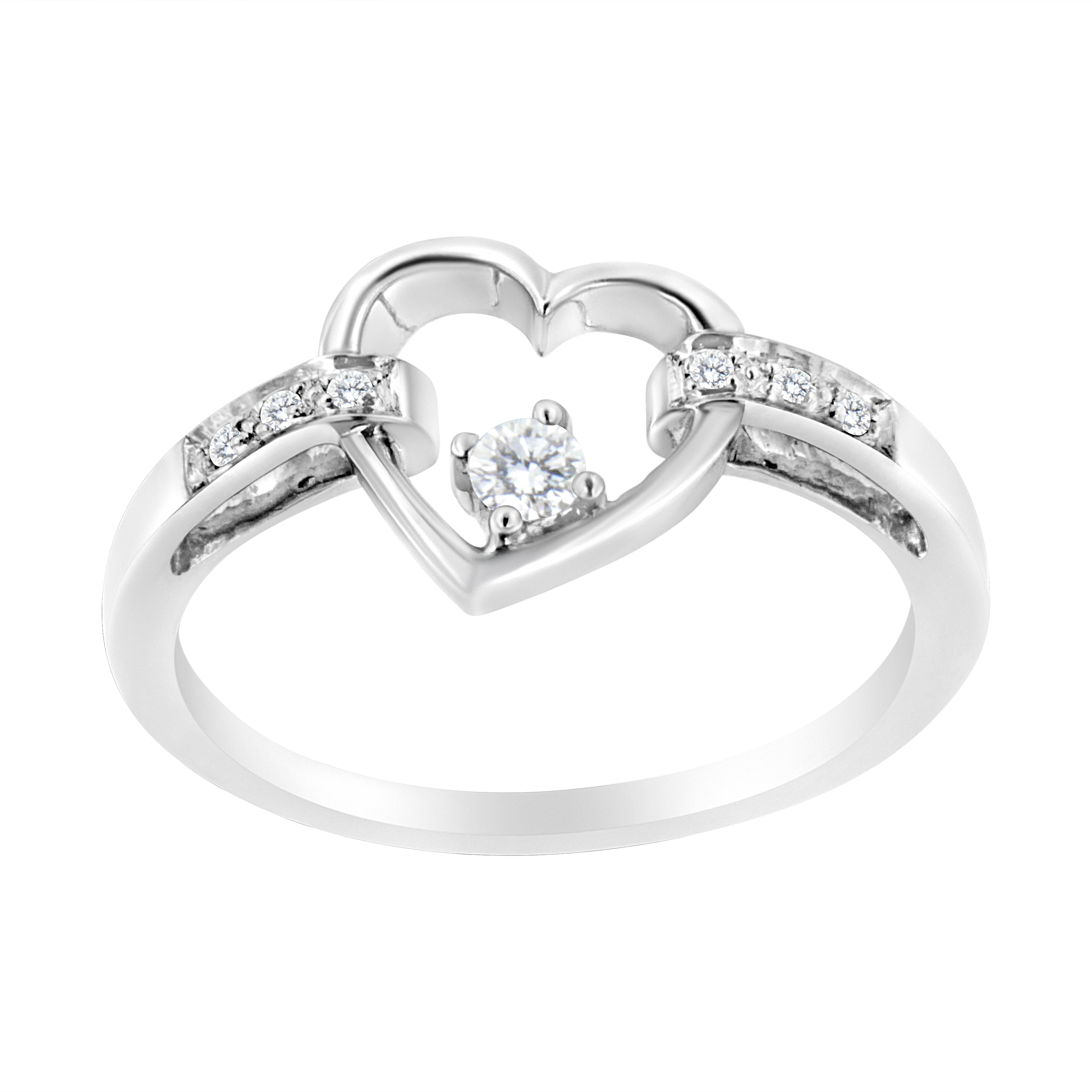 Gift your loved one with this cherished 1/8 c.t. diamond heart ring! This petite and elegant piece is crafted in 14k white gold, a metal that will stay tarnish free for years to come! It has an open heart motif at the center of the band with three