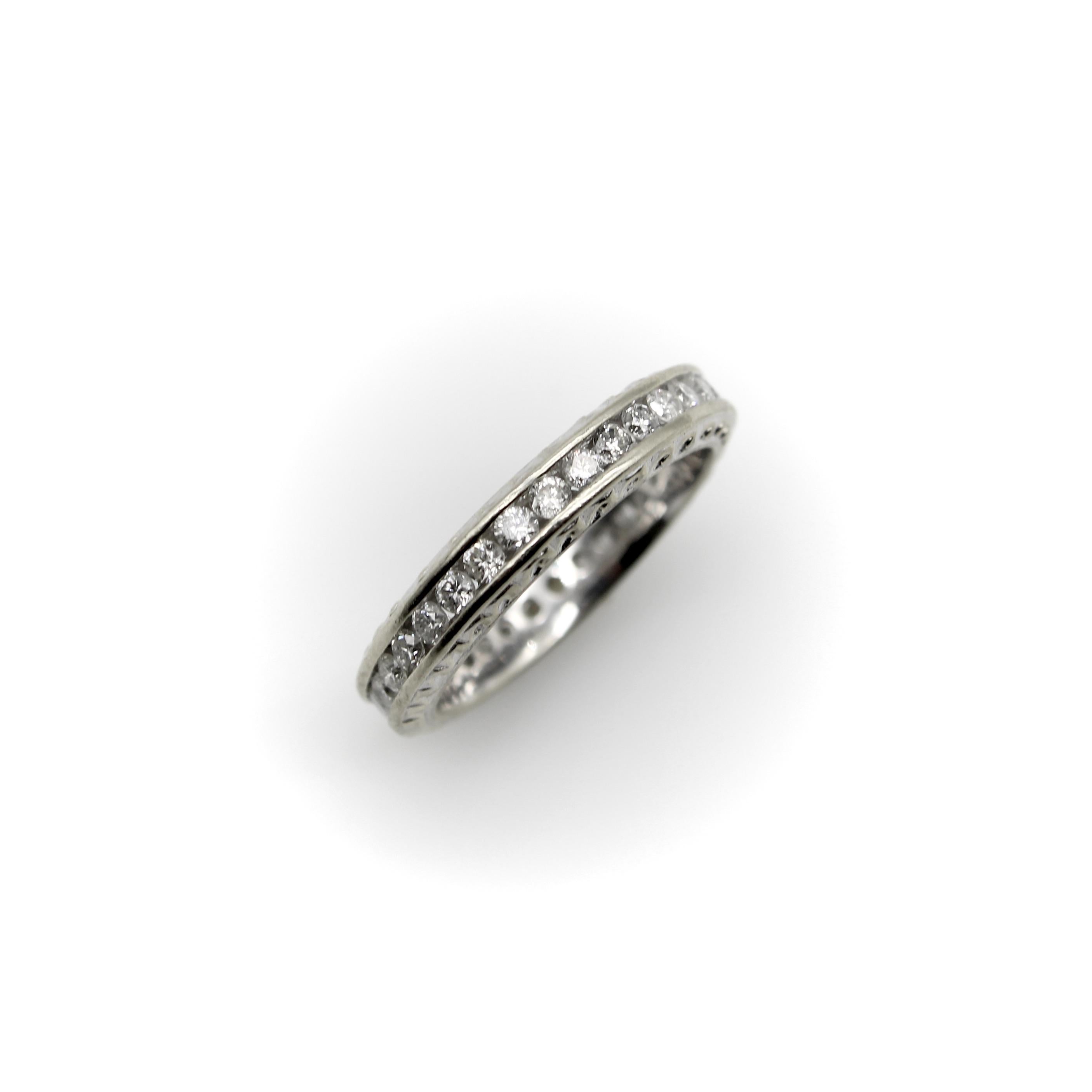 This beautiful 14k white gold ring is a classic diamond eternity band, with 33 channel set diamonds that encircle the band. The diamonds are bright and sparkly, and look lovely against the white gold. The sides of the band have a wave pattern that