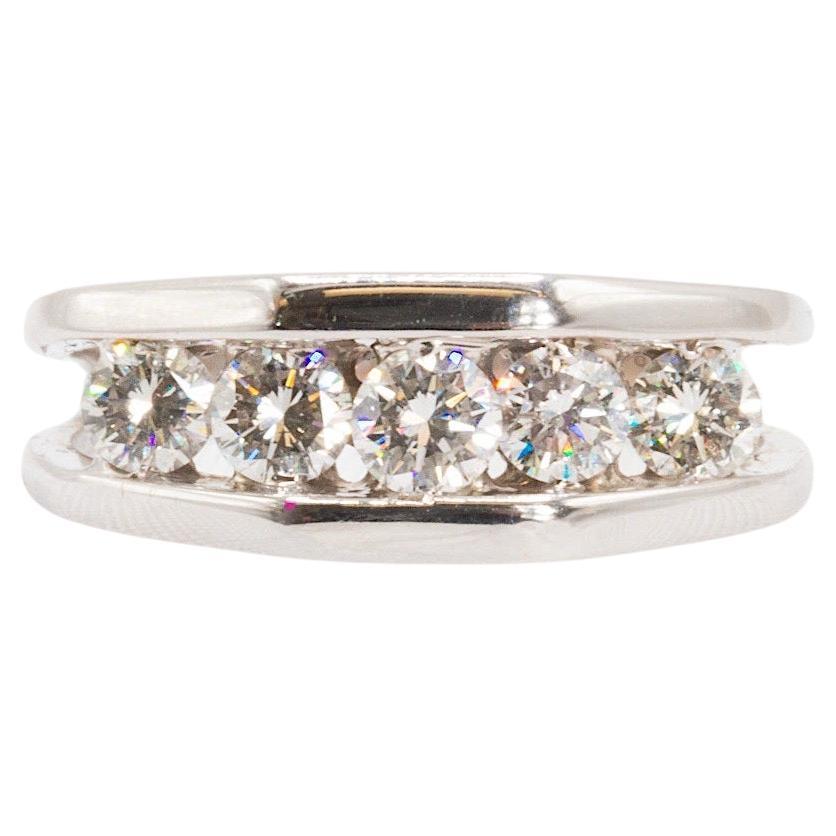 This pre-owned glittering channel-style wedding band is crafted in chromatic 14K white gold. Weighing 5.8g and tapering from 7.7 to 2.4mm, its resilient structure is designed to bring a lifetime of enjoyment from daily wear.

Five 0.20 ct. natural