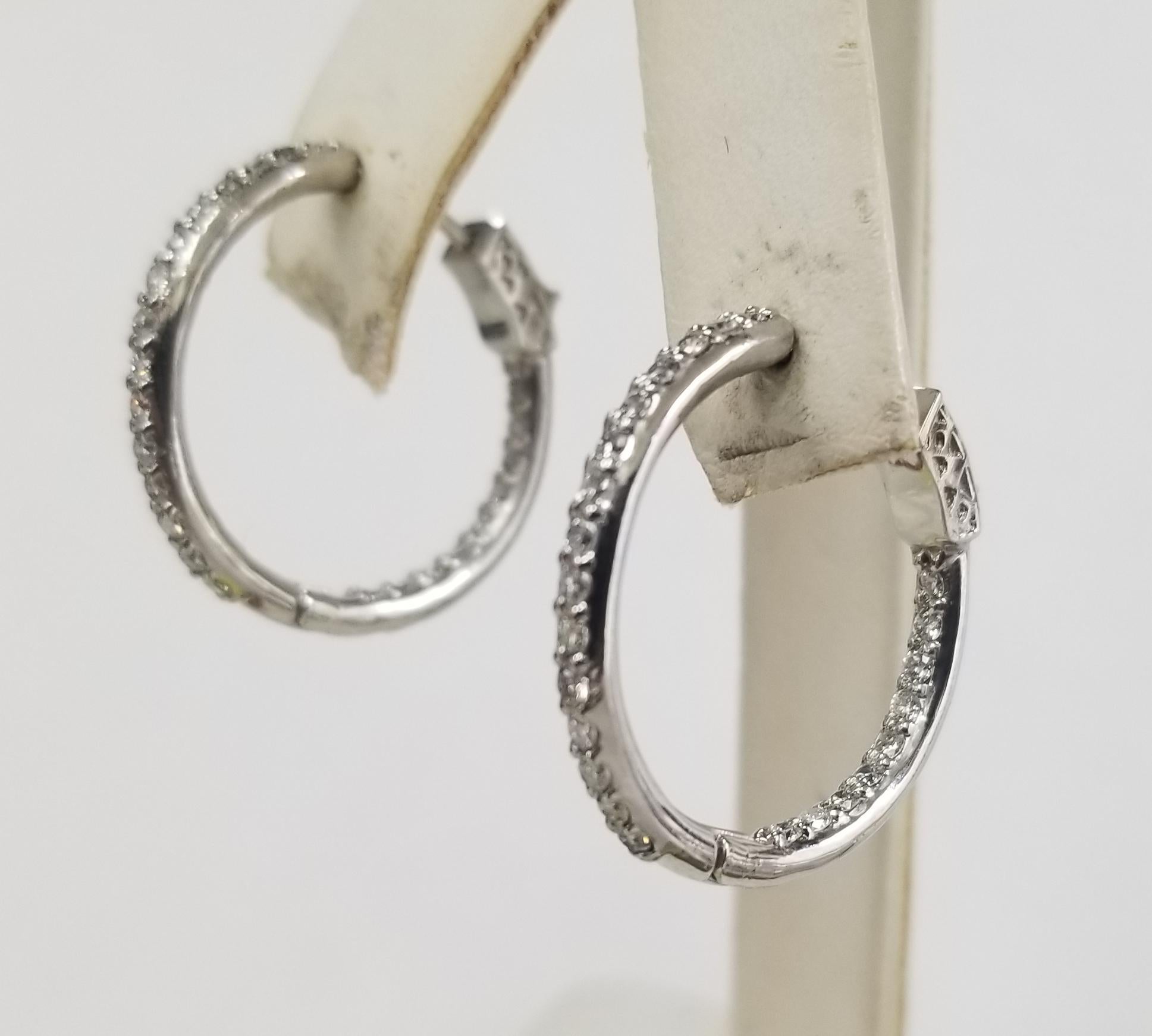 14k white gold 1 inch hoop diamond earrings, containing 48 round full cut diamonds of very fine quality weighing .80cts.