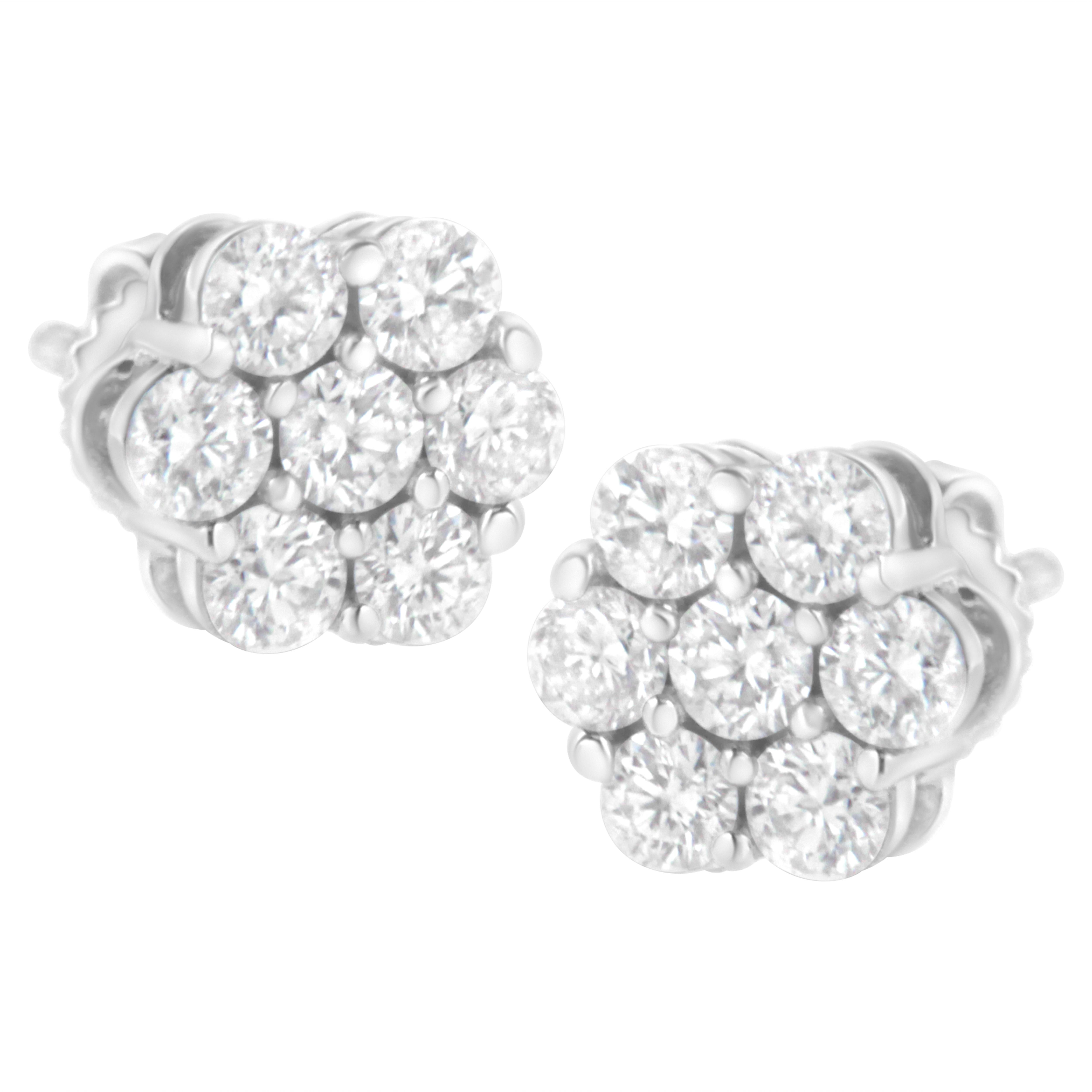 Classic and elegant, these diamond stud earrings are a must-have look any woman will adore. Created in 14K white gold, each earring features a glistening flower-shaped composite of shimmering round diamonds that catches the eye. A traditional look