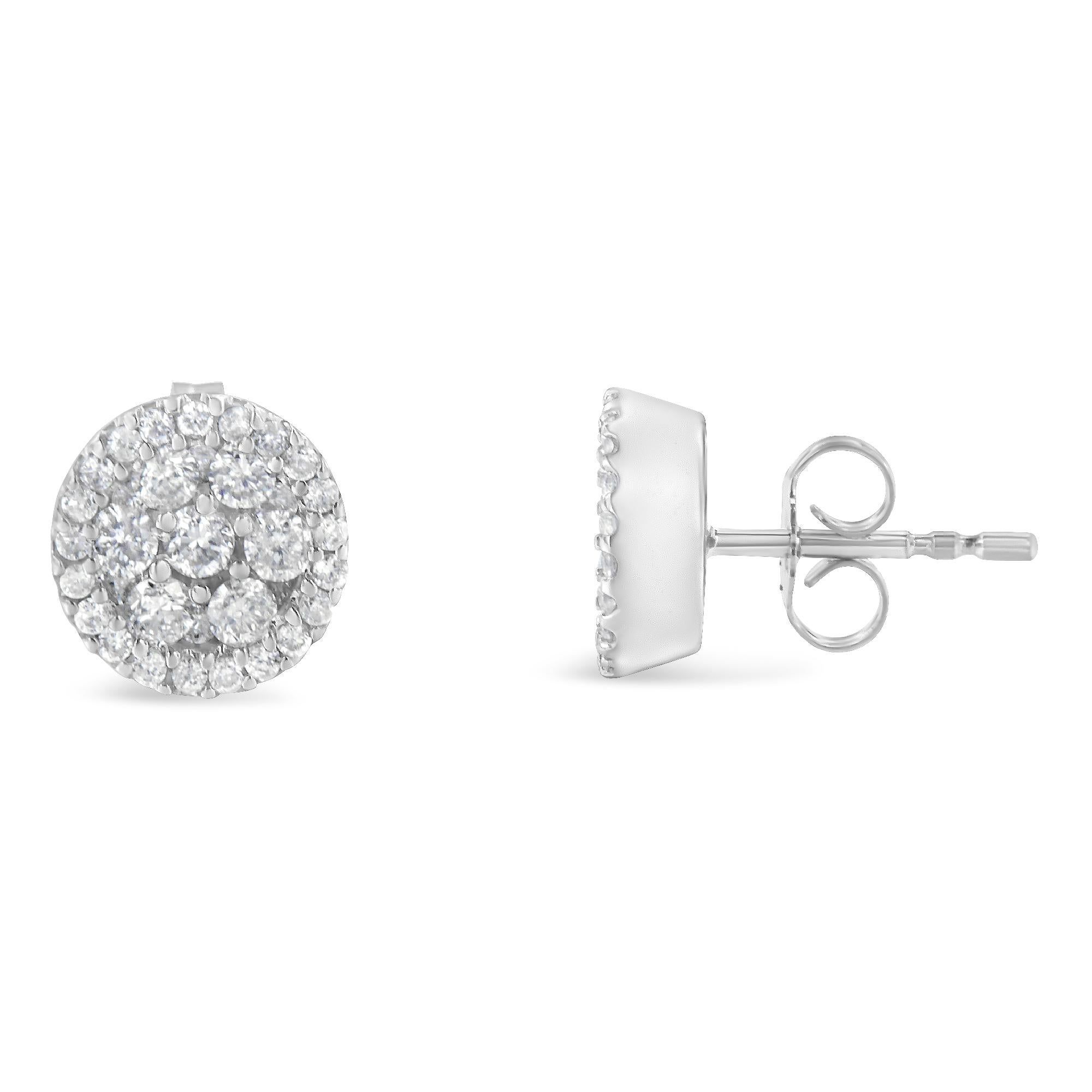 Elegant and timeless, these 14K white gold stud earrings feature round, brilliant cut diamonds in a halo style button shape. The earrings have three circular rows of diamonds with your choice of either ½ or 1.0 carat total weight worth of diamonds.