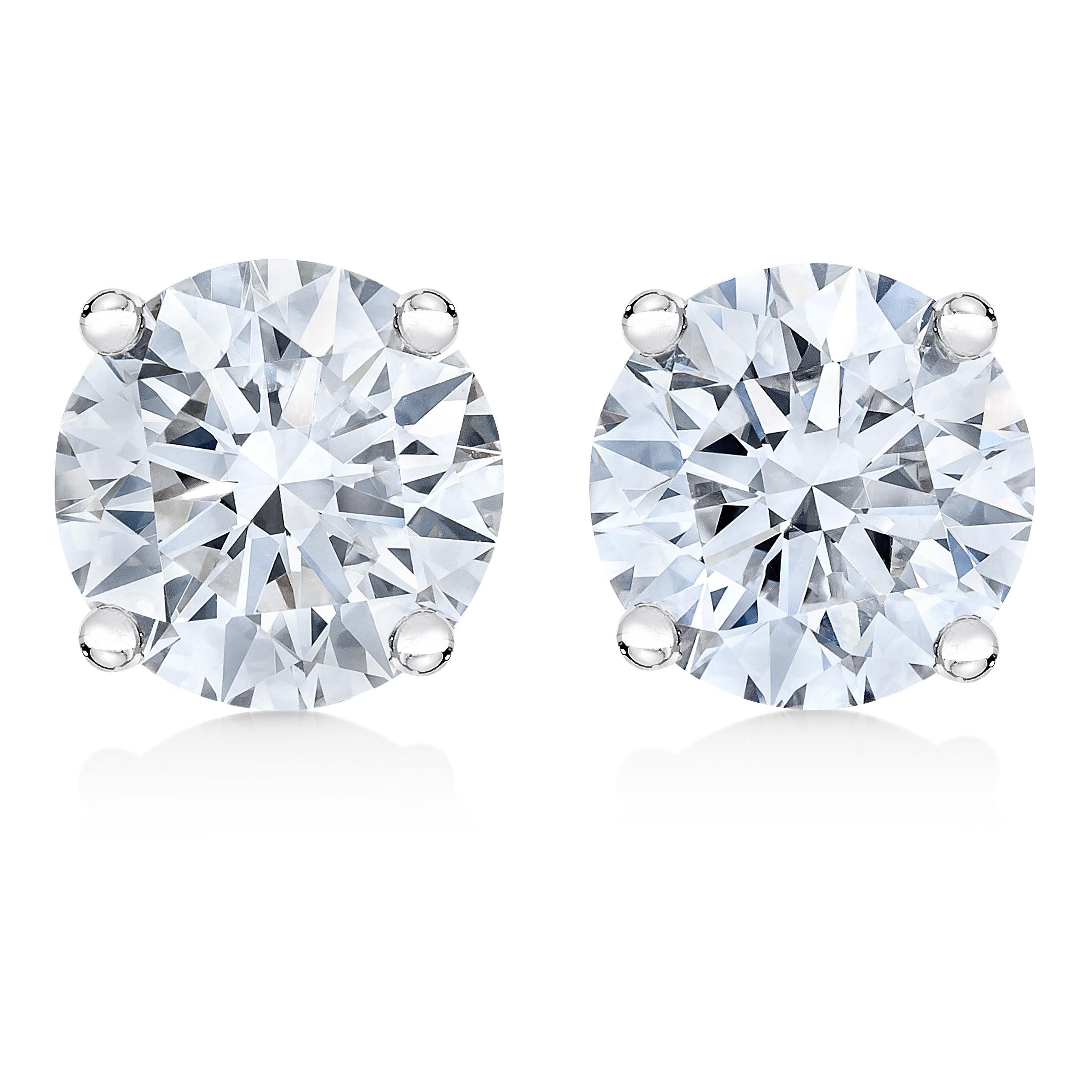 Two gorgeous white diamonds sit in a prong setting on these sparkling stud earrings. Crafted in cool weaves of 14K white gold, these diamond stud earrings feature a high polish finish and secure with a screw on mechanism. These stunning gold