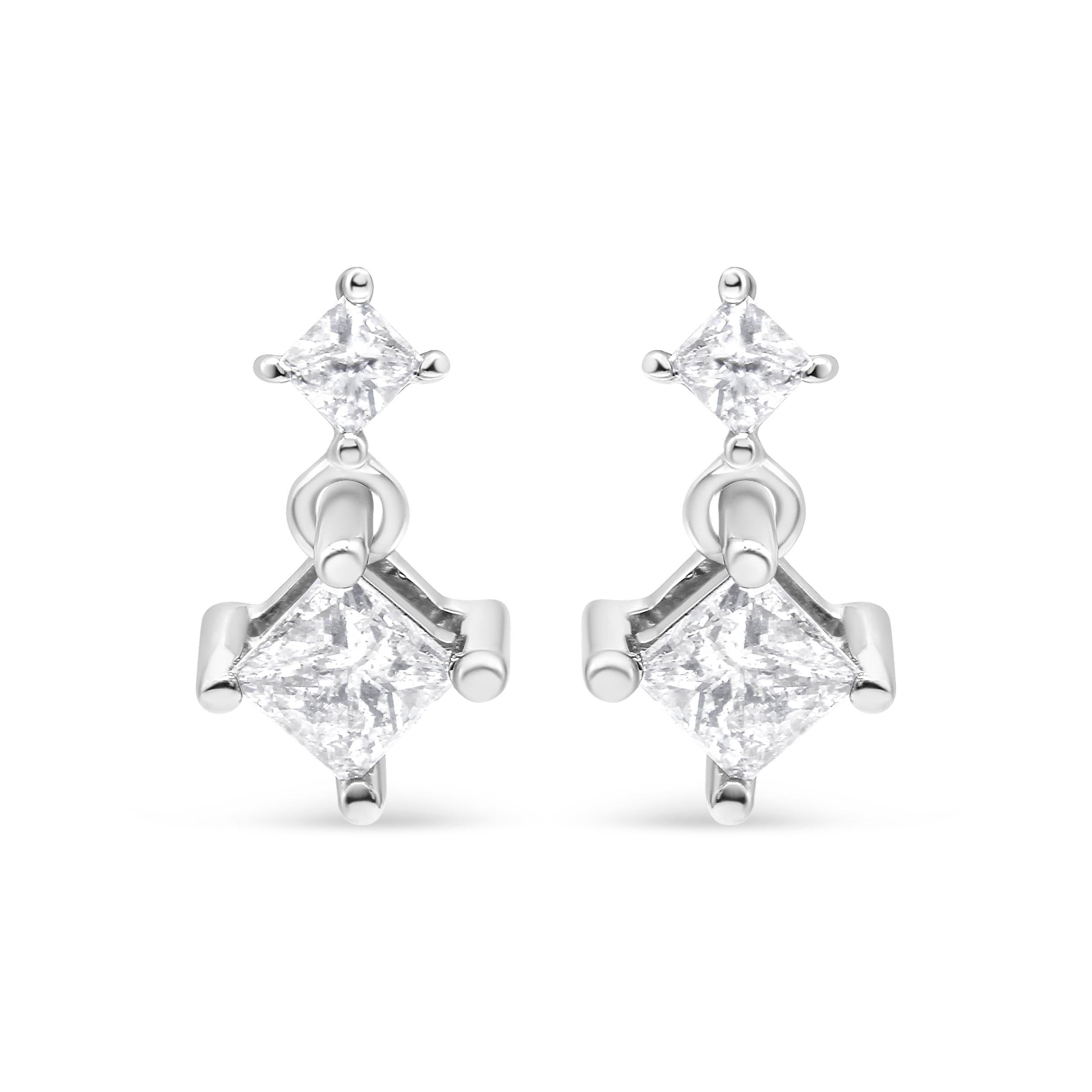 These lovely 14k white gold dangle earrings feature 1 ct. of diamonds. Two natural, princess-cut diamonds sit on top of each other. The design dangles from a push back finding and adds the perfect amount of sparkle to your everyday wear.

'Video