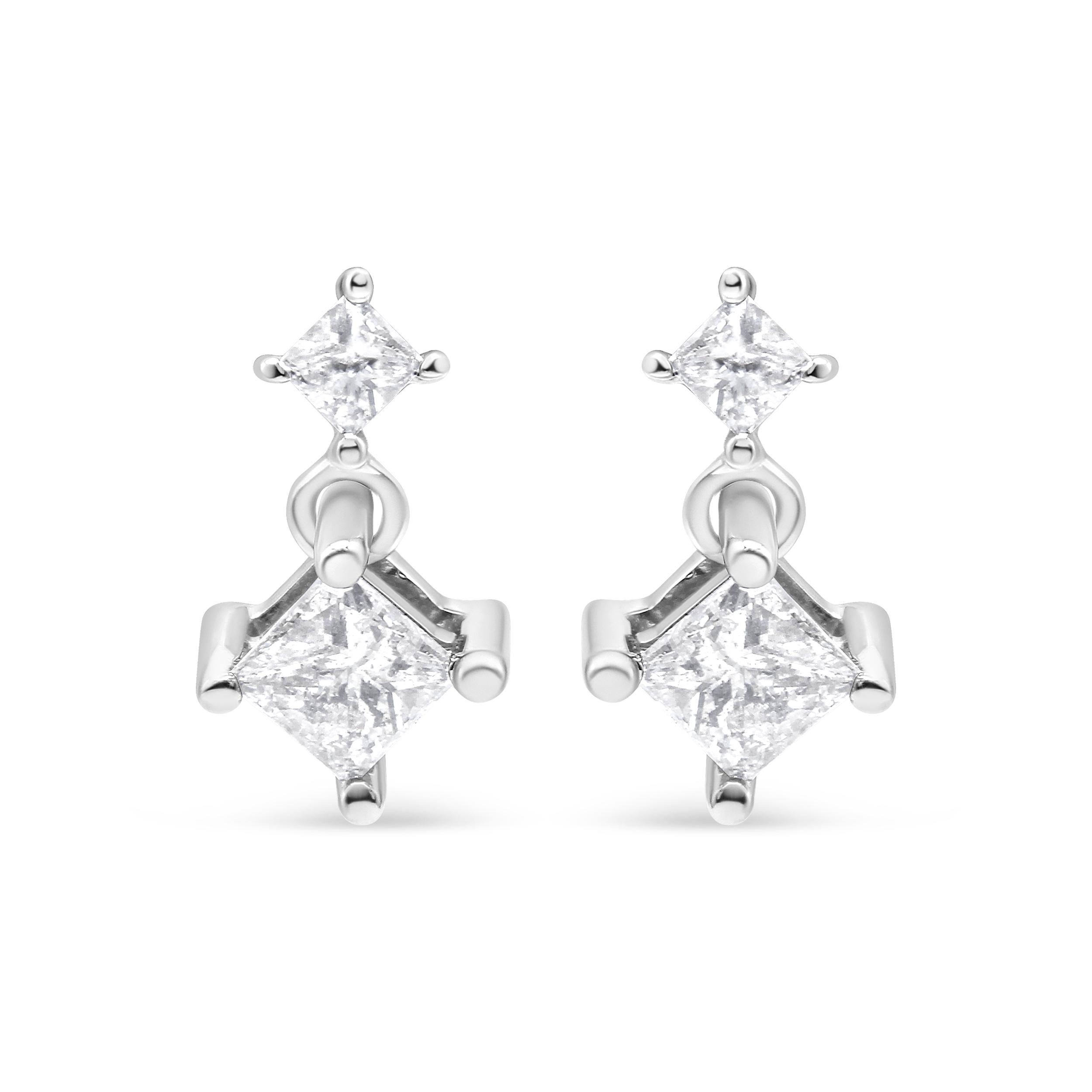 These lovely 14k white gold dangle earrings feature 1 ct. of diamonds. Two natural, princess-cut diamonds sit on top of each other. The design dangles from a push back finding and adds the perfect amount of sparkle to your everyday wear.

'Video