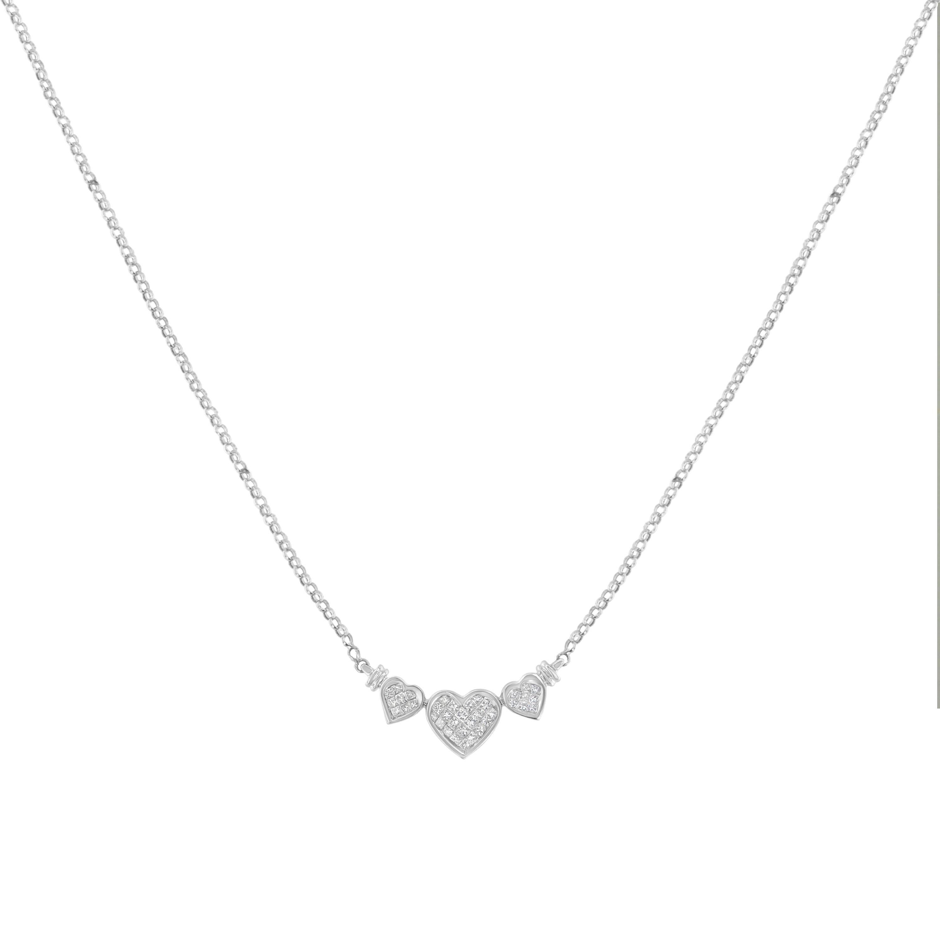 Experience the elegance and romance with this stunning statement necklace, featuring a captivating design of one large heart nestled between two smaller ones, all intricately set with multiple princess cut diamonds in an invisible setting. This