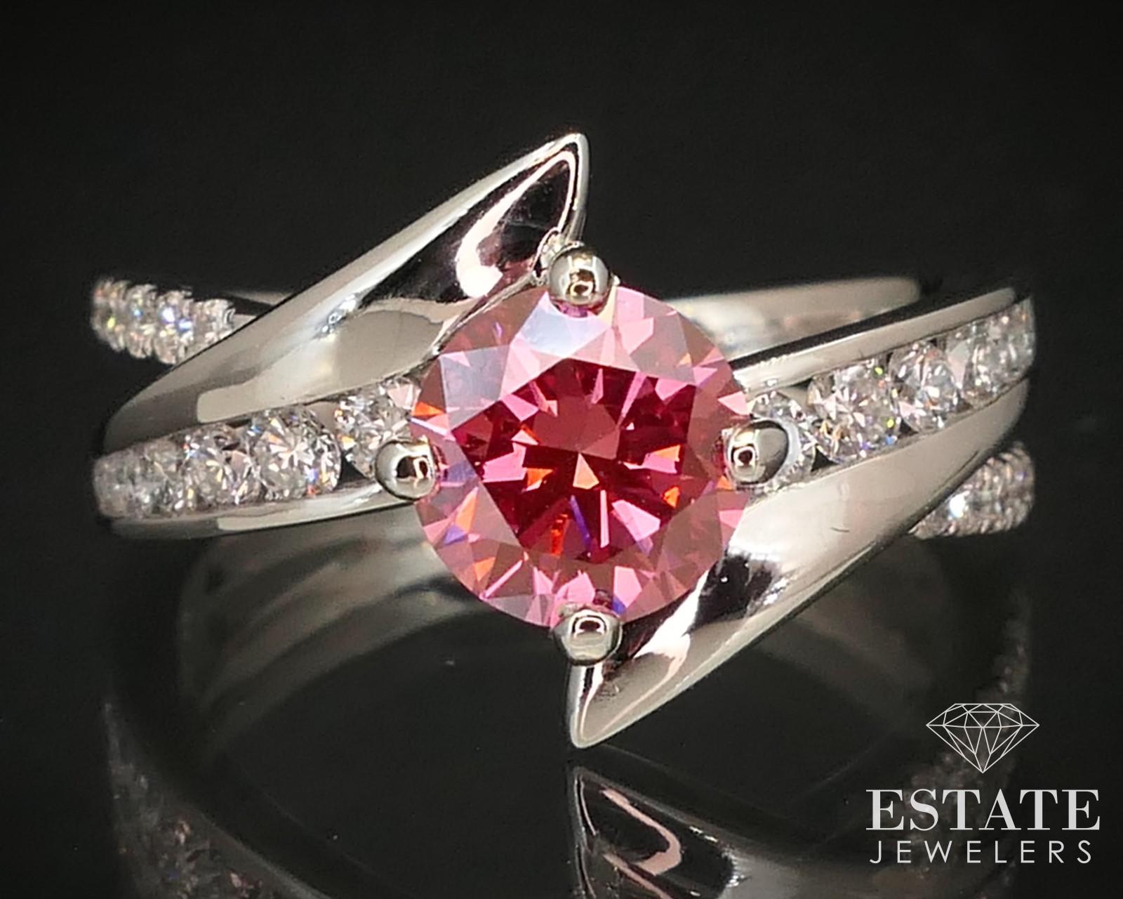 Stunning white gold bypass engagement ring with a IGI certified VIVID 1.04ct lab pink diamond in the middle and approximately .53ctw of diamond accents . VS1 clarity to it. stamped 14k. IGI number LG588348454 SIZE-6.5