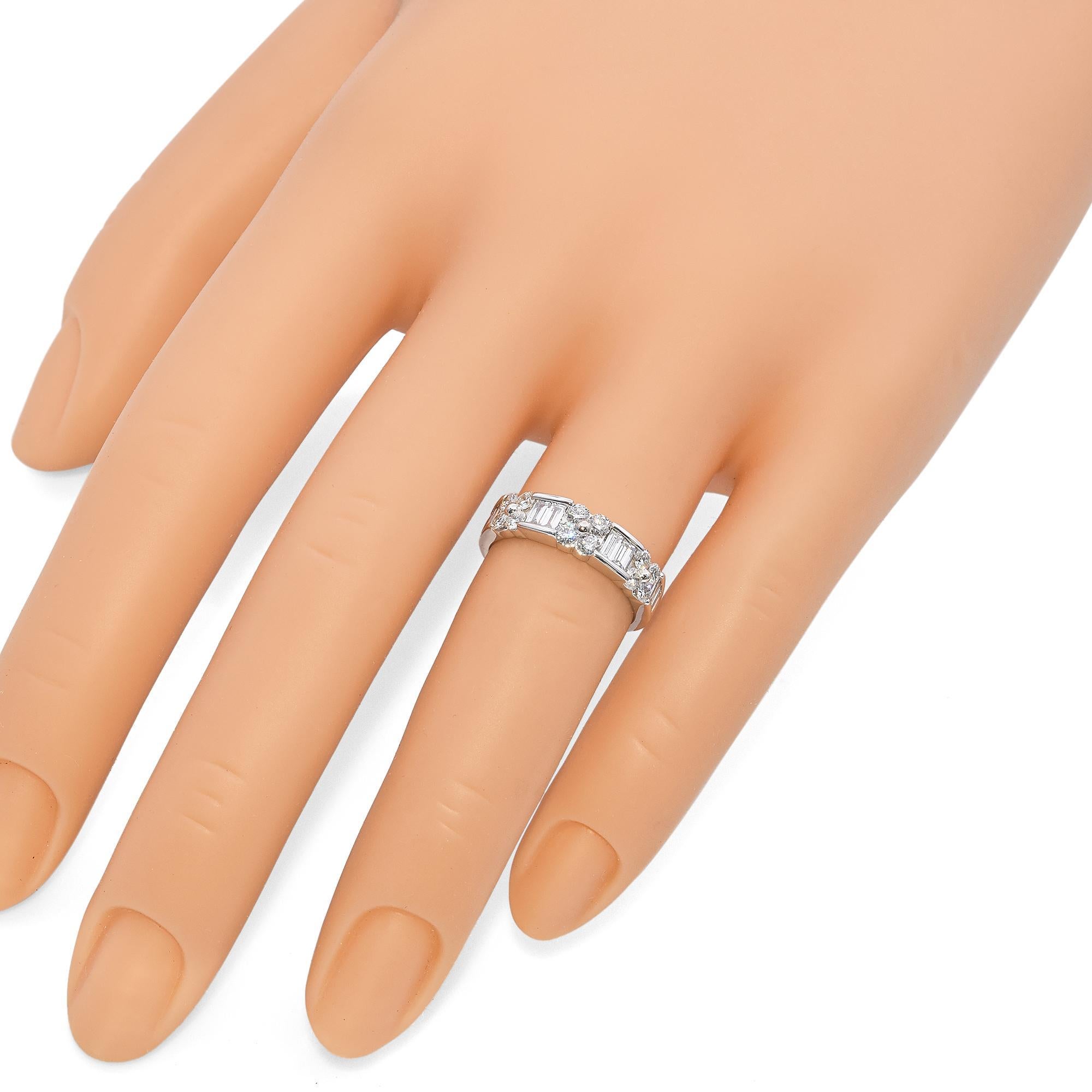 This elegant ring is crafted in white gold. It features a series of round brilliant cut diamonds, interspersed with baguette cut diamonds, creating a striking geometric pattern. The round diamonds are set in clusters, enhancing their brilliance and