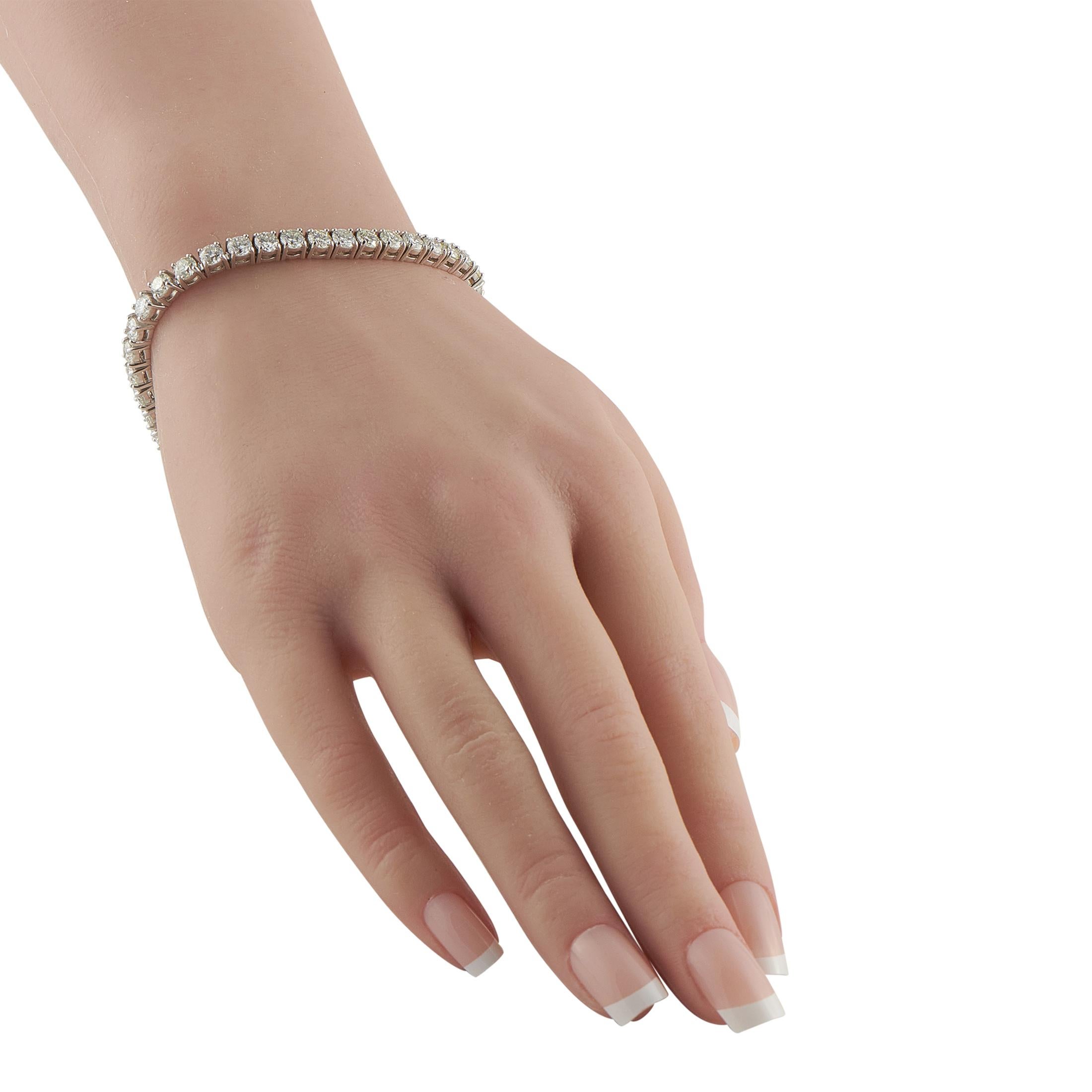 This 14K white gold tennis bracelet showcases an impressive 10.5 carats of diamonds, with each stone matched for fire, clarity, and uniform brilliance. The substantial carat weight gives the piece an unmistakable presence. Its clean, continuous line