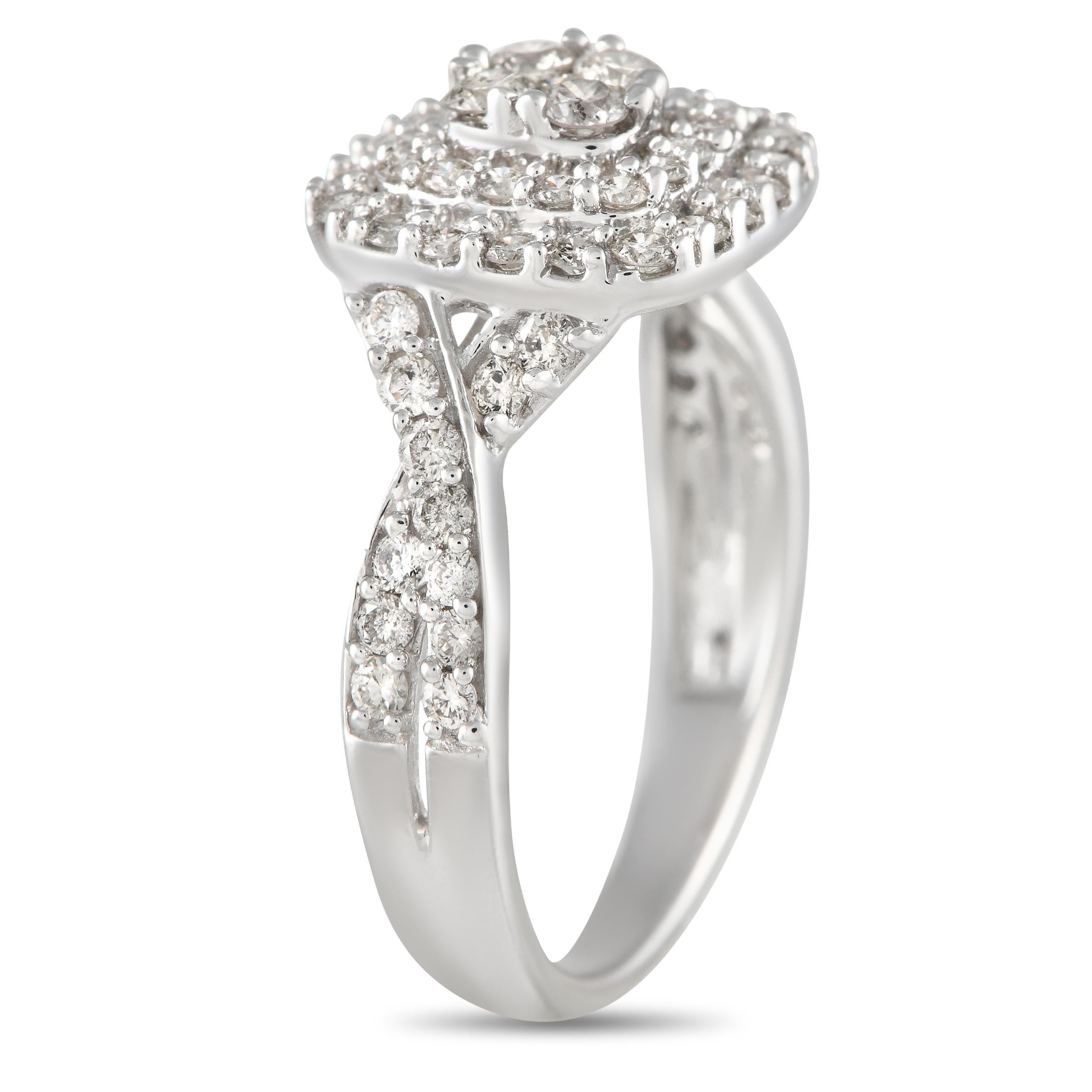 A beautiful diamond ring designed with the perfect blend of regal beauty and retro aesthetics. This 14K white gold ring has a 3mm-thick band with twisted shoulders traced with round diamonds. They lead to tiered cushion-shaped halos of more