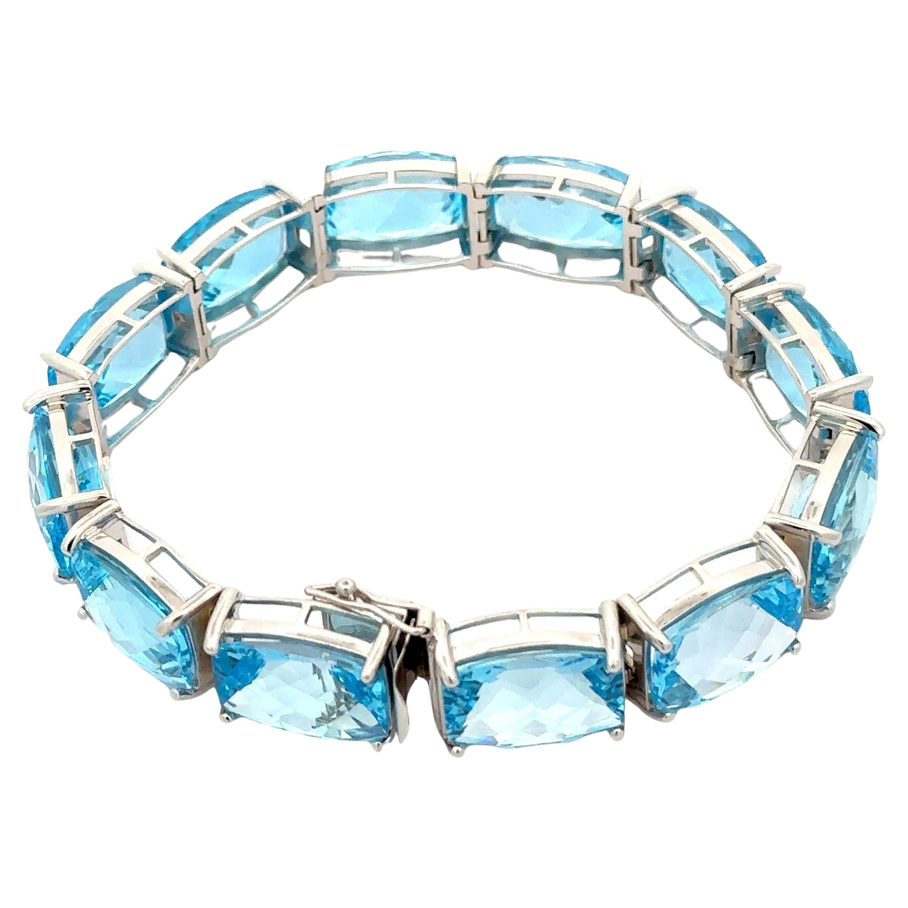 -Pierre(s)
(12) Topaze véritable naturelle - taille coussin rectangulaire - sertie - couleur bleu clair - 14.9x10.88x7.4mm chaque - 112.80ctw (approx.)

MATERIAL : Or blanc massif 14k 
Poids : 50,90 grammes
Type : Lien de ligne
Longueur : Mesurer