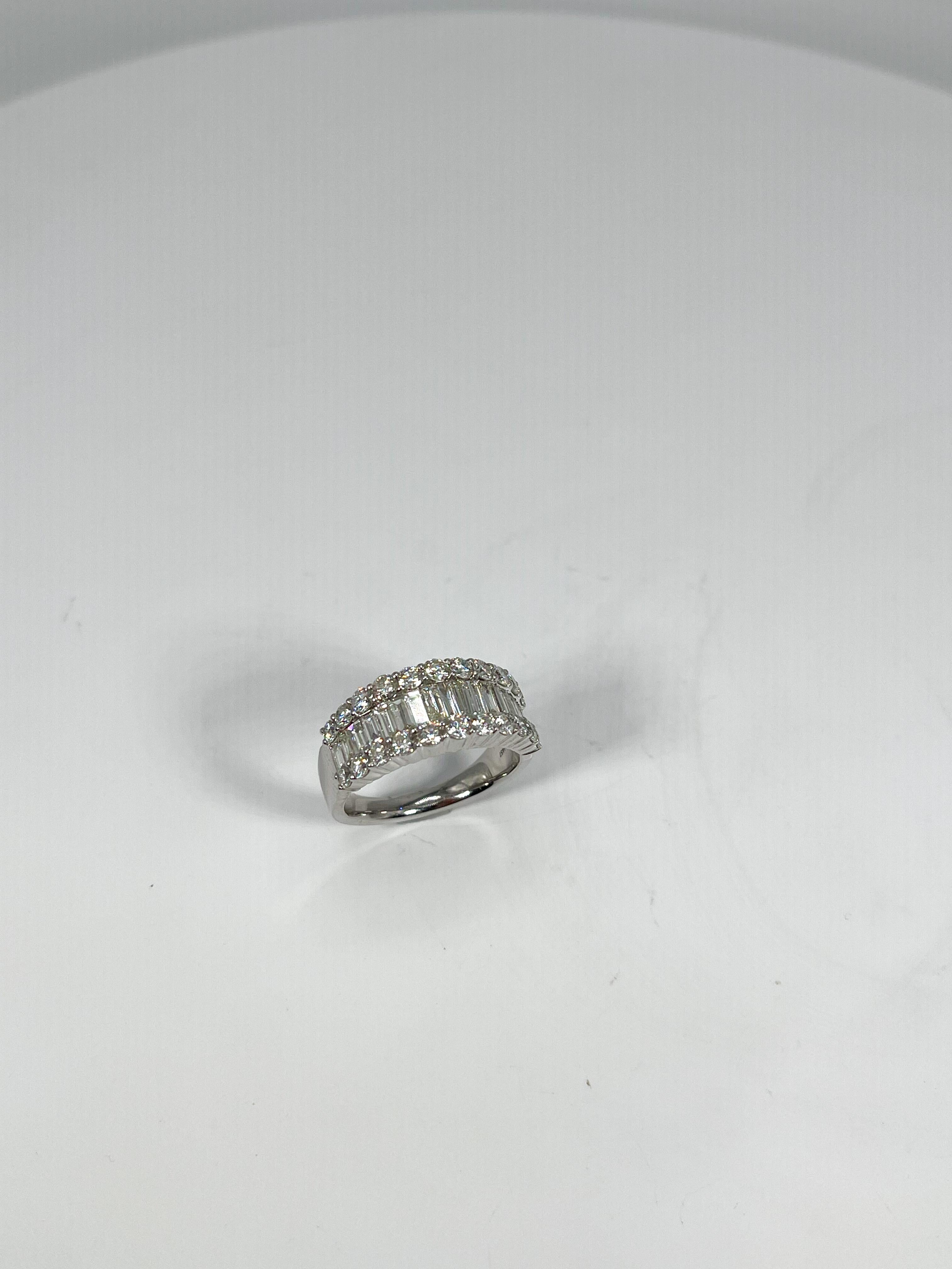 14k white gold 1.15 CTW baguette and .90 CTW round diamond band. The Band has baguettes in the center, and round diamonds going along the top. The Width of the ring is 8.6 mm, has a weight of 6.86, and the size of the ring is a 7. 