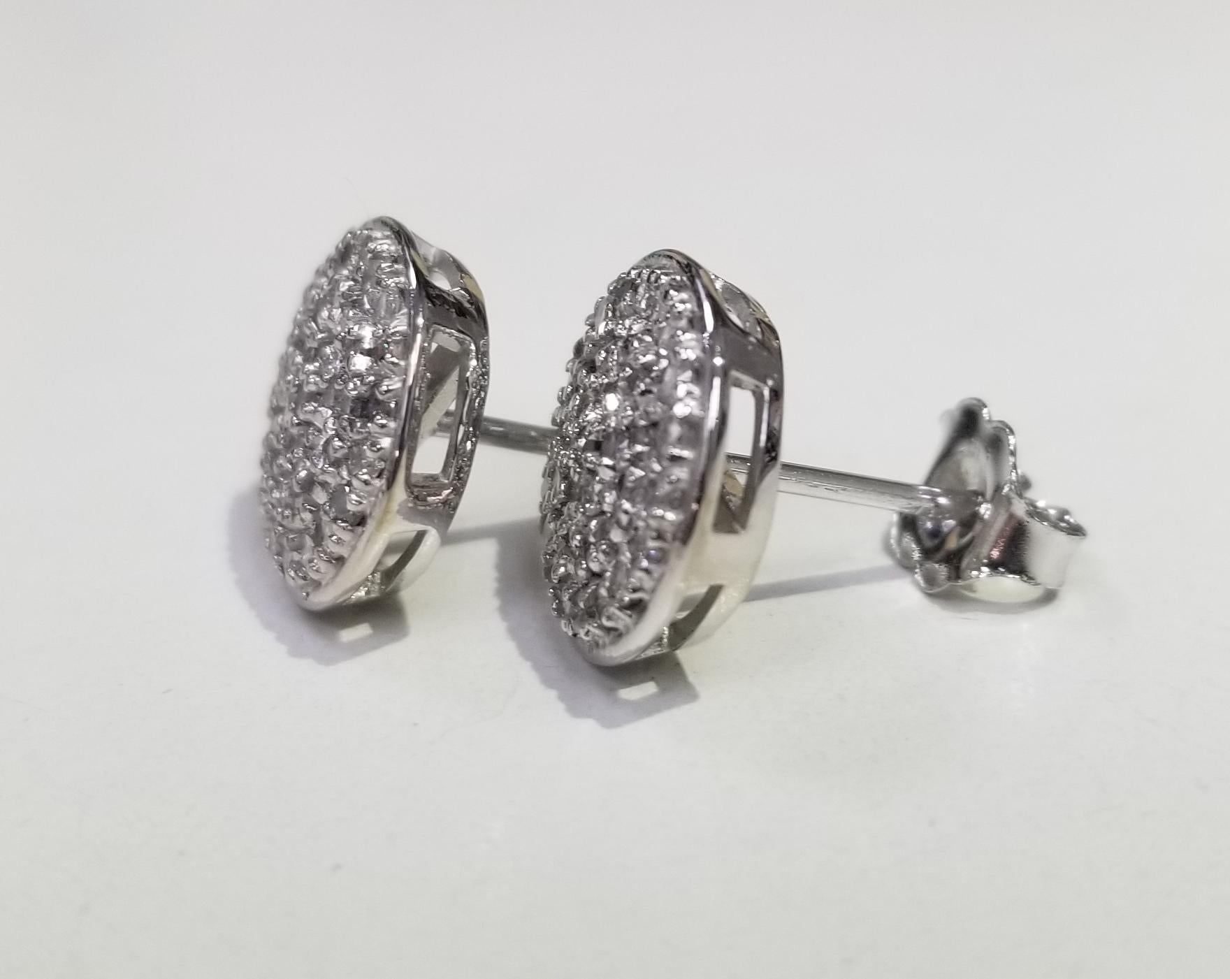14k white gold 11mm diamond cluster round earrings pave' set with 78 round full cut diamonds weighing .75pts.
