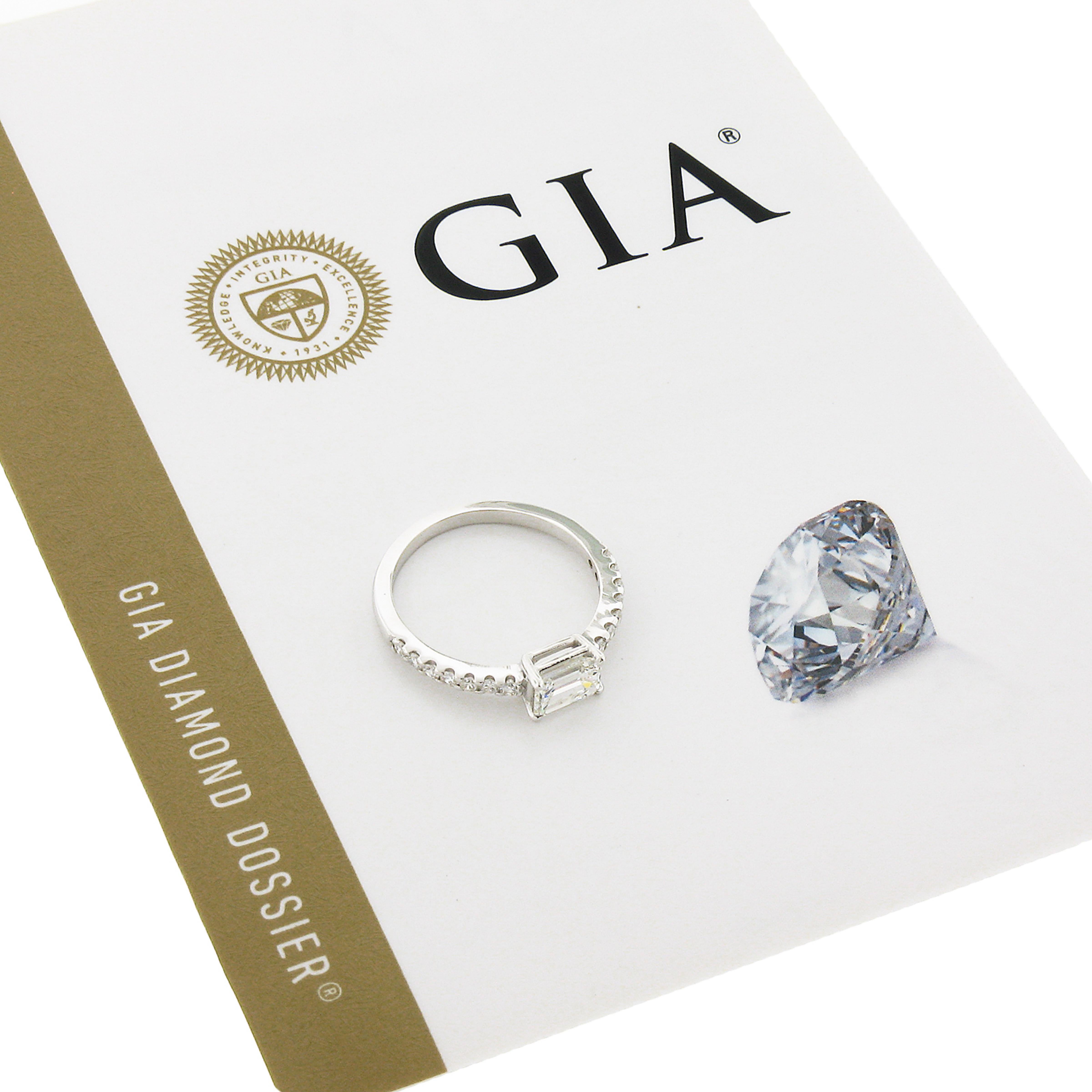 This chic and super stylish diamond sideways ring is newly crafted in solid 14k white gold and features a beautiful, GIA certified emerald cut diamond solitaire prong set at its center. This solitaire stone is accented on either side with a set of