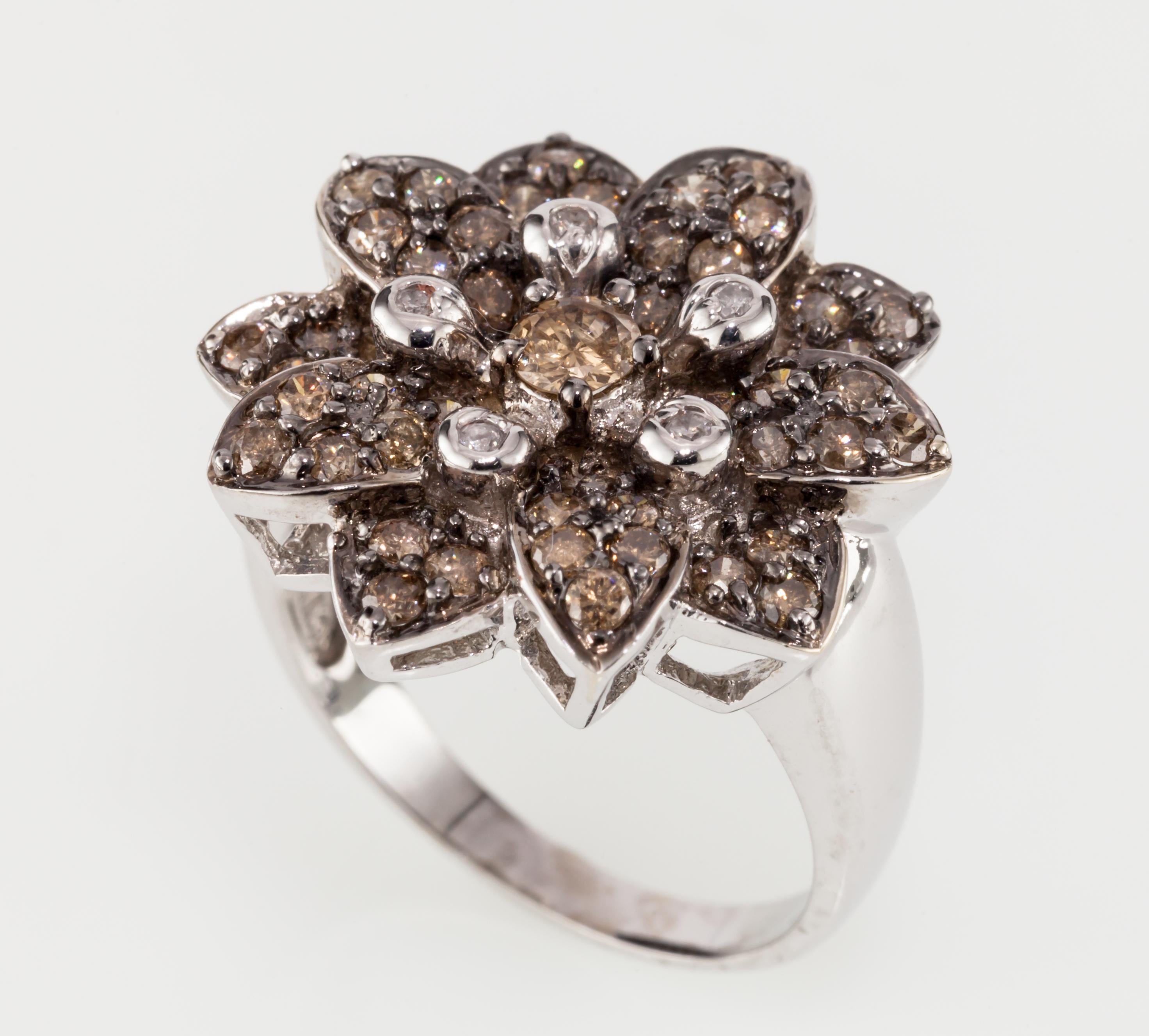 Features round fancy chocolate and white diamonds, bead set in a flower setting with a large round chocolate diamond in center.
14K white gold.
Size: 7.
Diameter of Flower: 20 mm.
Total Diamond Weight: 1.22 carat.
Weight: 7.1 grams.