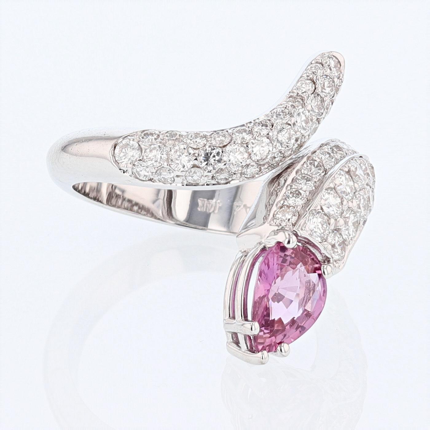 This ring is made in 14k white gold and features a 1.25ct pear shape pink sapphire prong set for the center stone. The ring also features 69 round cut diamonds pave set on the shank of the ring weighing 1.46ct total color grade (H) clarity grade