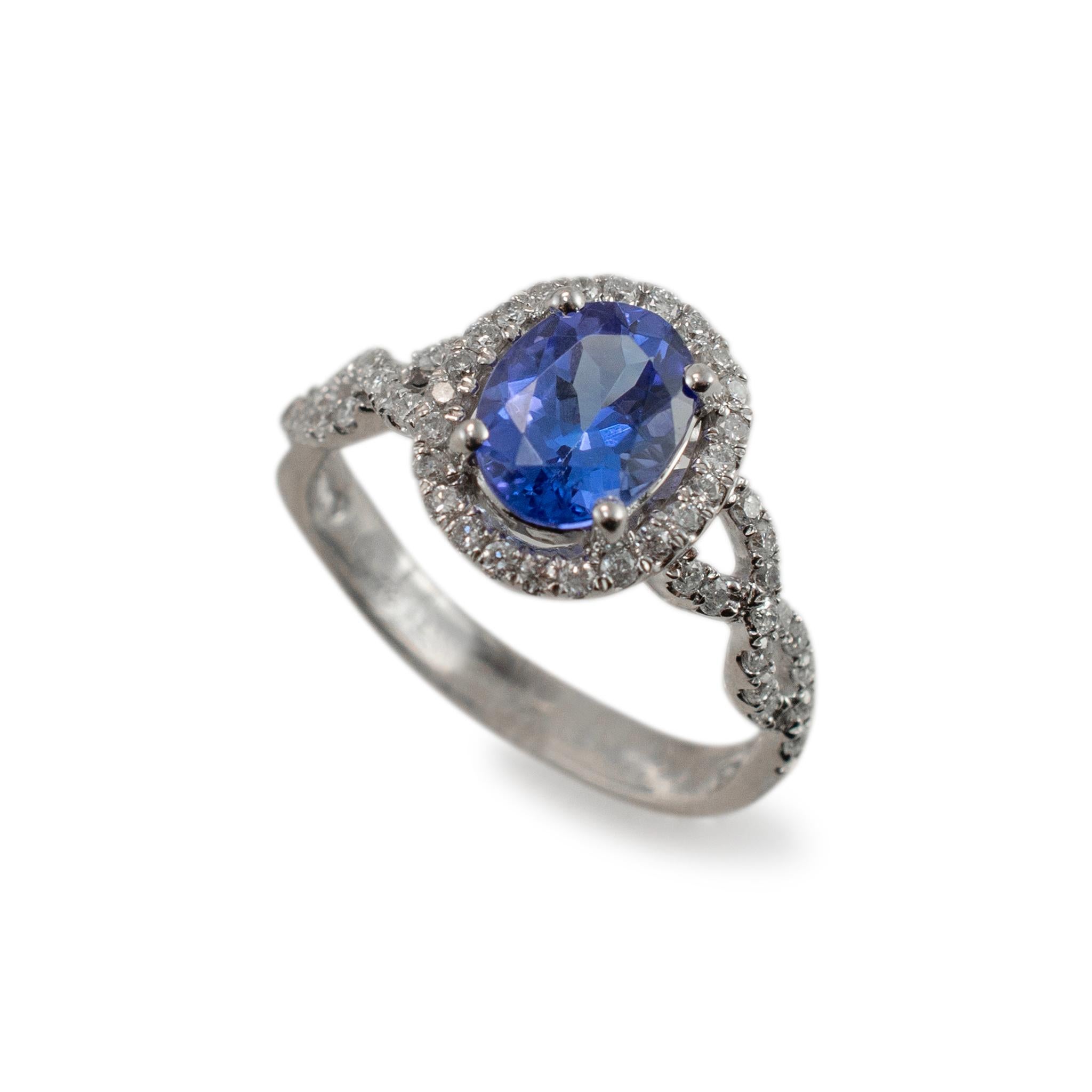 Gender: Ladies

Metal Type: 14K White Gold

Ring Size: 5.5

Weight: 3.20 grams

One ladies Rhodium plated 14K white gold diamond and tanzanite cocktail, halo ring with a flat shank. Engraved with 