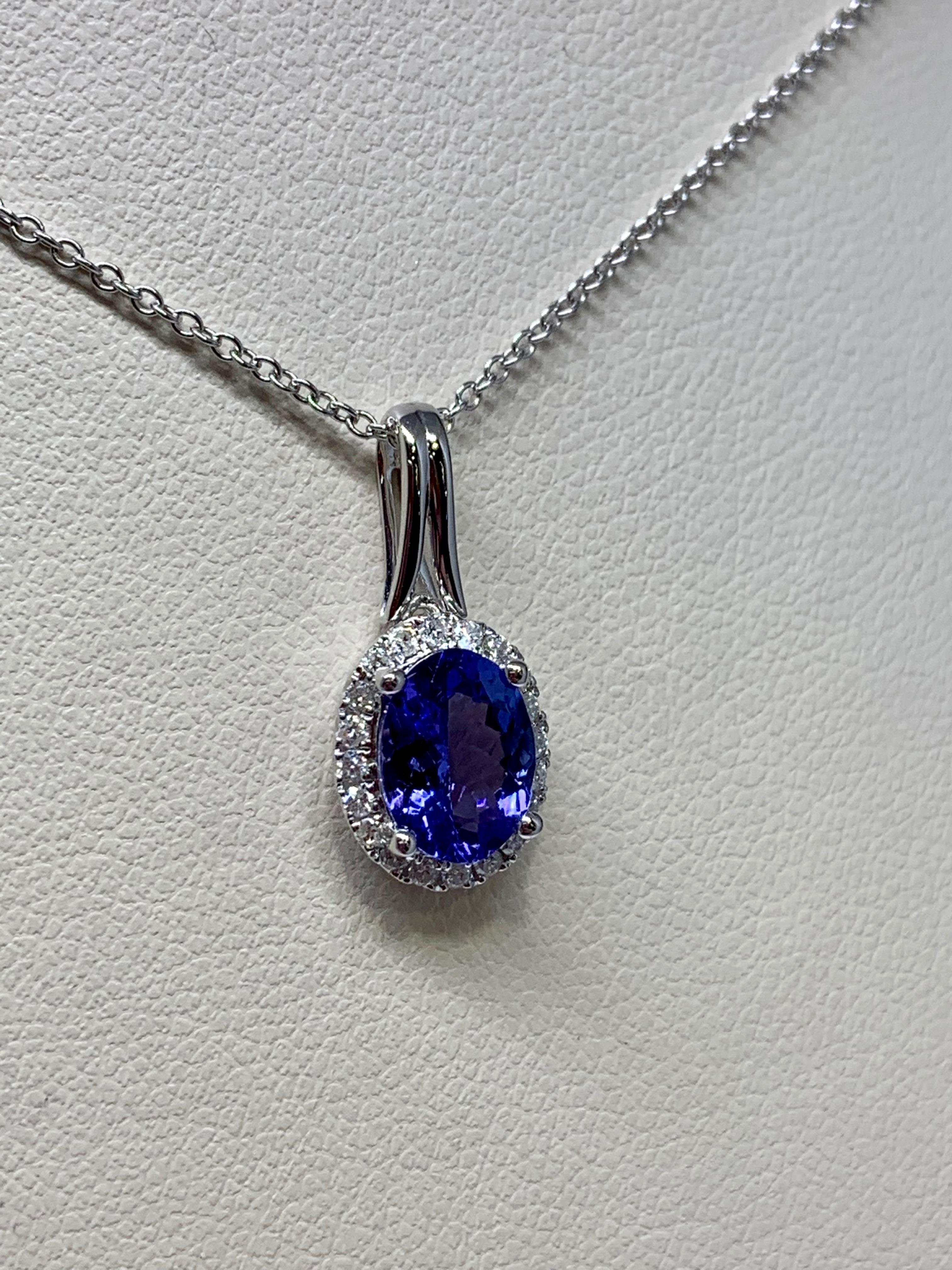 This classic pendant features a beautiful 1.24 carat oval-shaped tanzanite center stone. The vibrant purple shade contrasts perfectly against the 0.14 carat round diamond halo. This necklace includes an 18 inch white gold cable chain with a sturdy