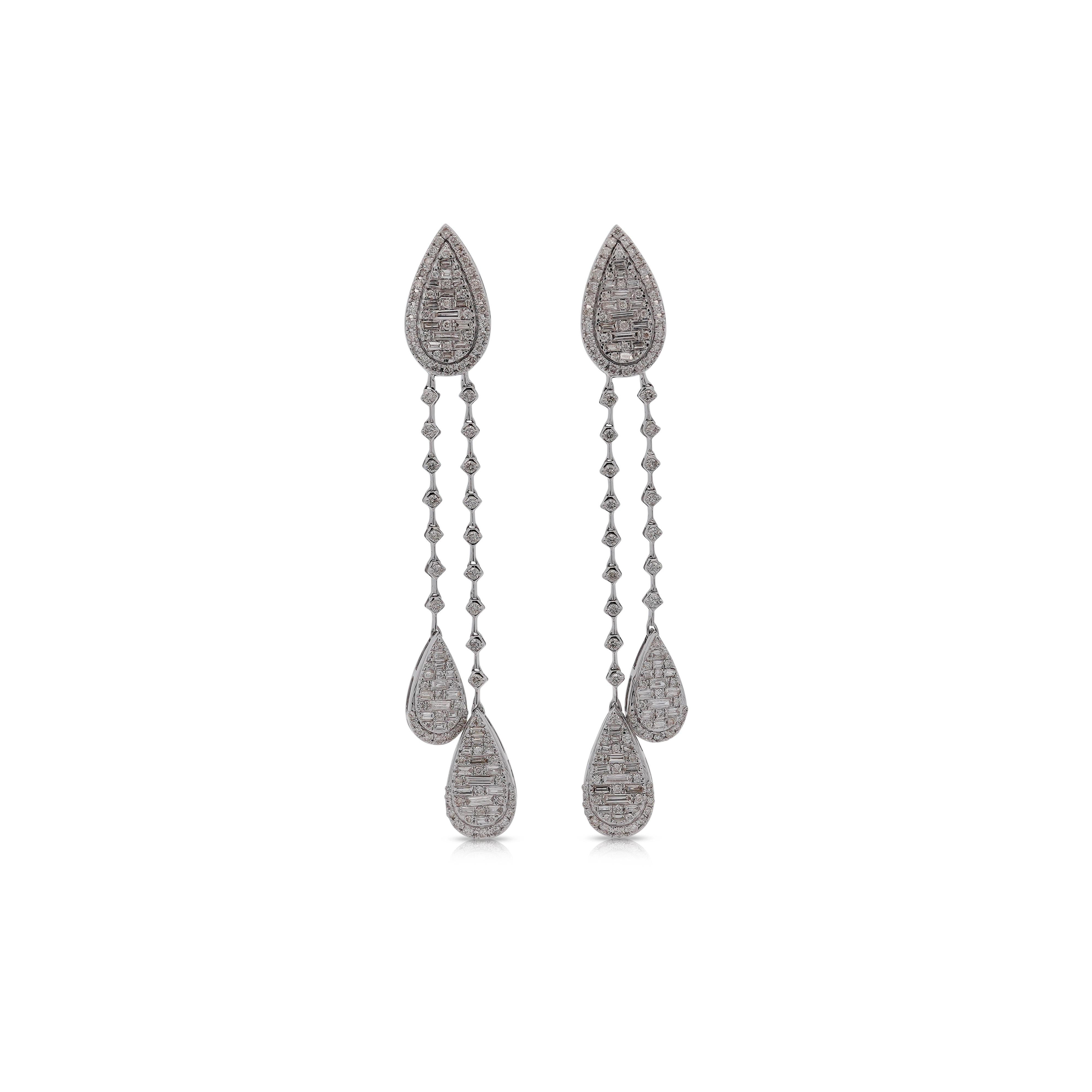 14K White Gold Pear Shape Drop Diamond Earrings feature a total of 1.41 carat diamonds. The diamonds are graded G-H in color and SI1-SI2 for clarity.

The earrings showcase a pear-shaped drop design, measuring 2.4 inches in length. The top piece,