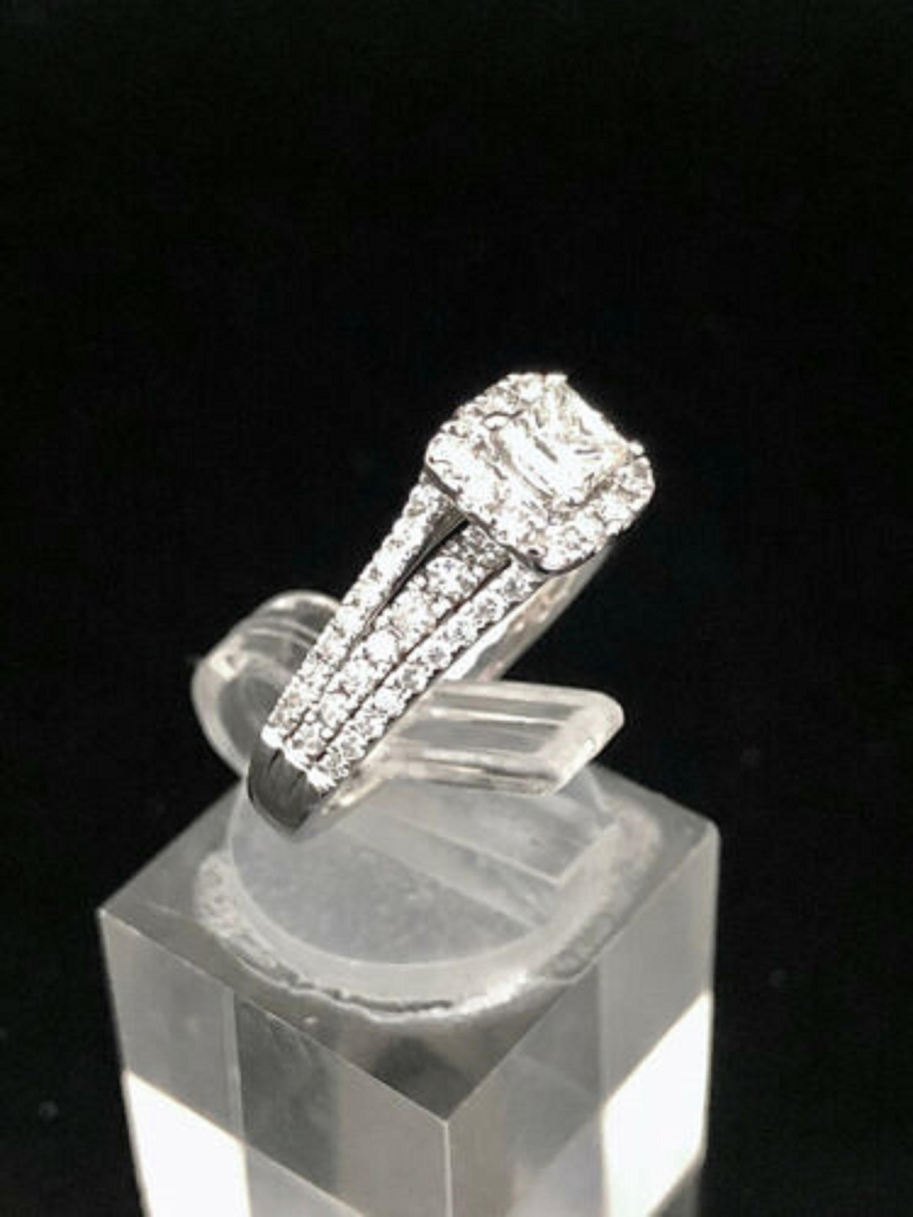 Up for sale:

This great looking solid 14k white gold princess cut natural diamond halo with round cut natural diamond accents engagement ring. This ring is featuring a 1.50 ctw princess and round diamonds
Center Diamond: G color; SI2 clarity (eye