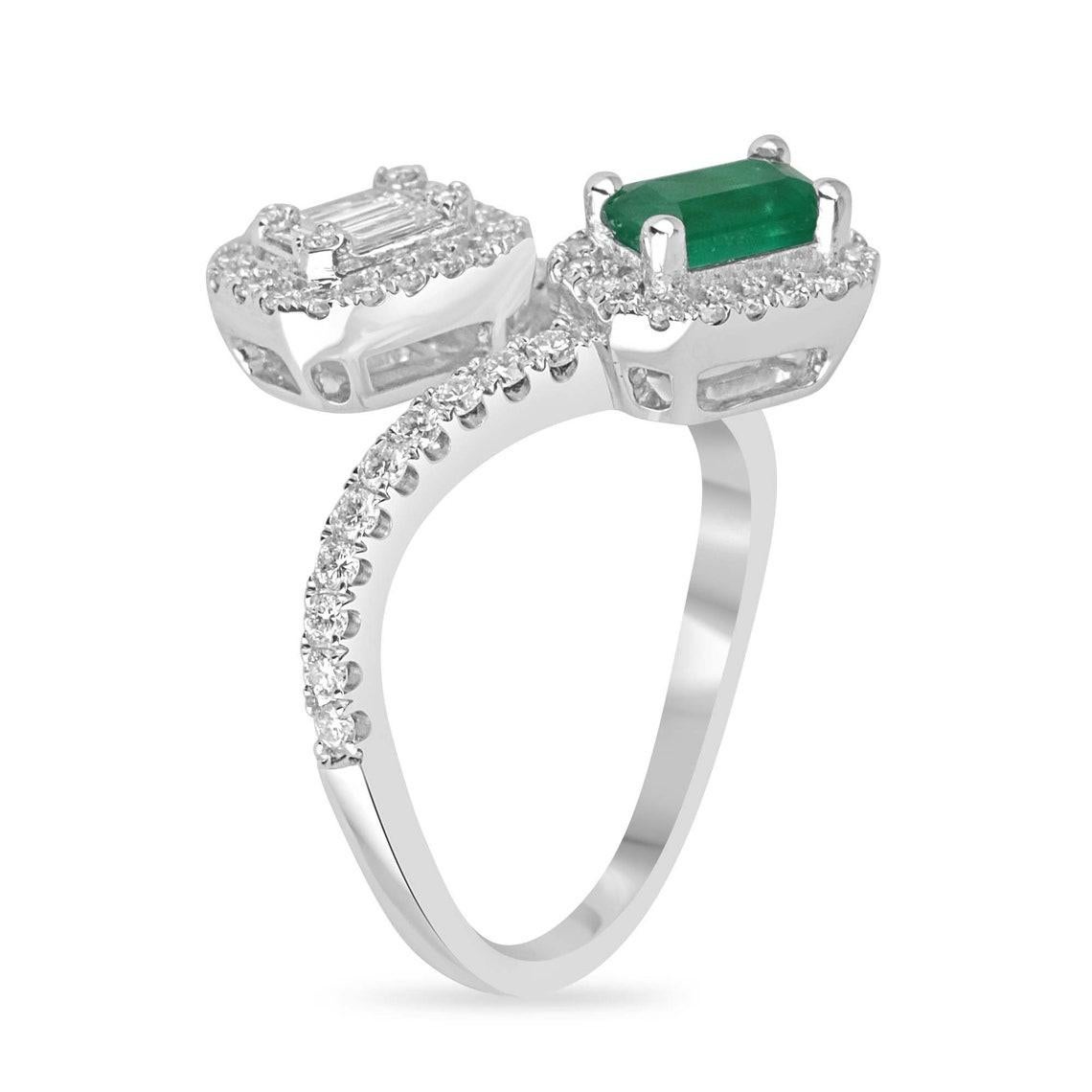 Elevate your jewelry collection with our exquisite Emerald and Diamond Toi et Moi Ring. This stunning piece showcases a captivating emerald cut emerald from Colombia, weighing over 0.80 carats, and is surrounded by a dazzling array of brilliant