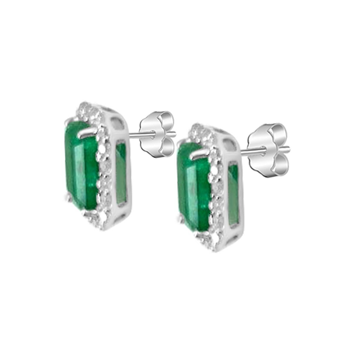 Featured Here Is A Stunning Emerald And Diamond Stud Earring In Fine 14K White Gold Displayed Are Vivacious Green 7X5mm Emerald Accented By A Simple Four Prong Setting. 
These Emeralds Have A Desirable Lush Green Color With Execellent Qualities
