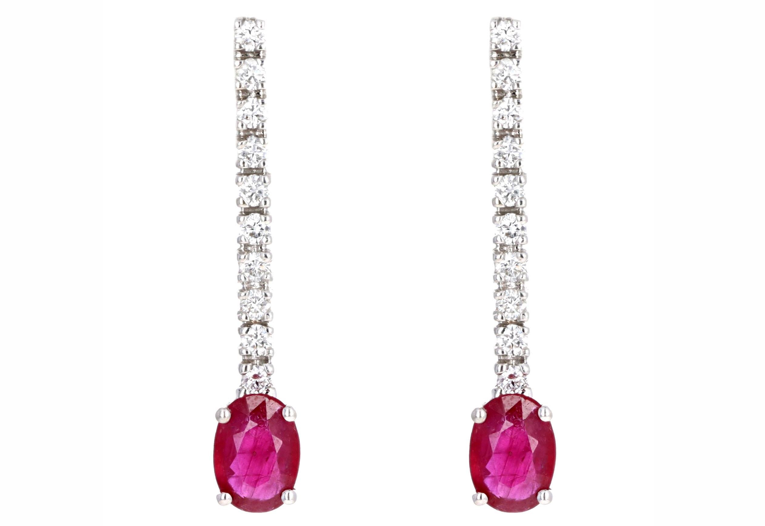 Era: Modern Estate

Composition: 14K White Gold

Primary Stone: Two Oval Cut Natural Rubies

Carat Weight: Approximately 1.80 Carats in Total

Accent Stone: Twenty Round Brilliant Cut Diamonds

Carat Weight: Approximately 0.50 Carats in