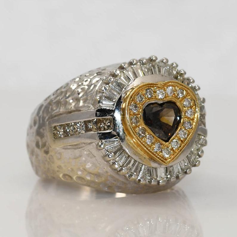Ladies custom made diamond ring in14k white gold setting.
Stamped 14k and weighs 22.4 grams.
The black center diamond is heart shaped, 1.31 carats.
There are champagne colored, princess cuts on the sides, VS clarity.
Also, there are round and